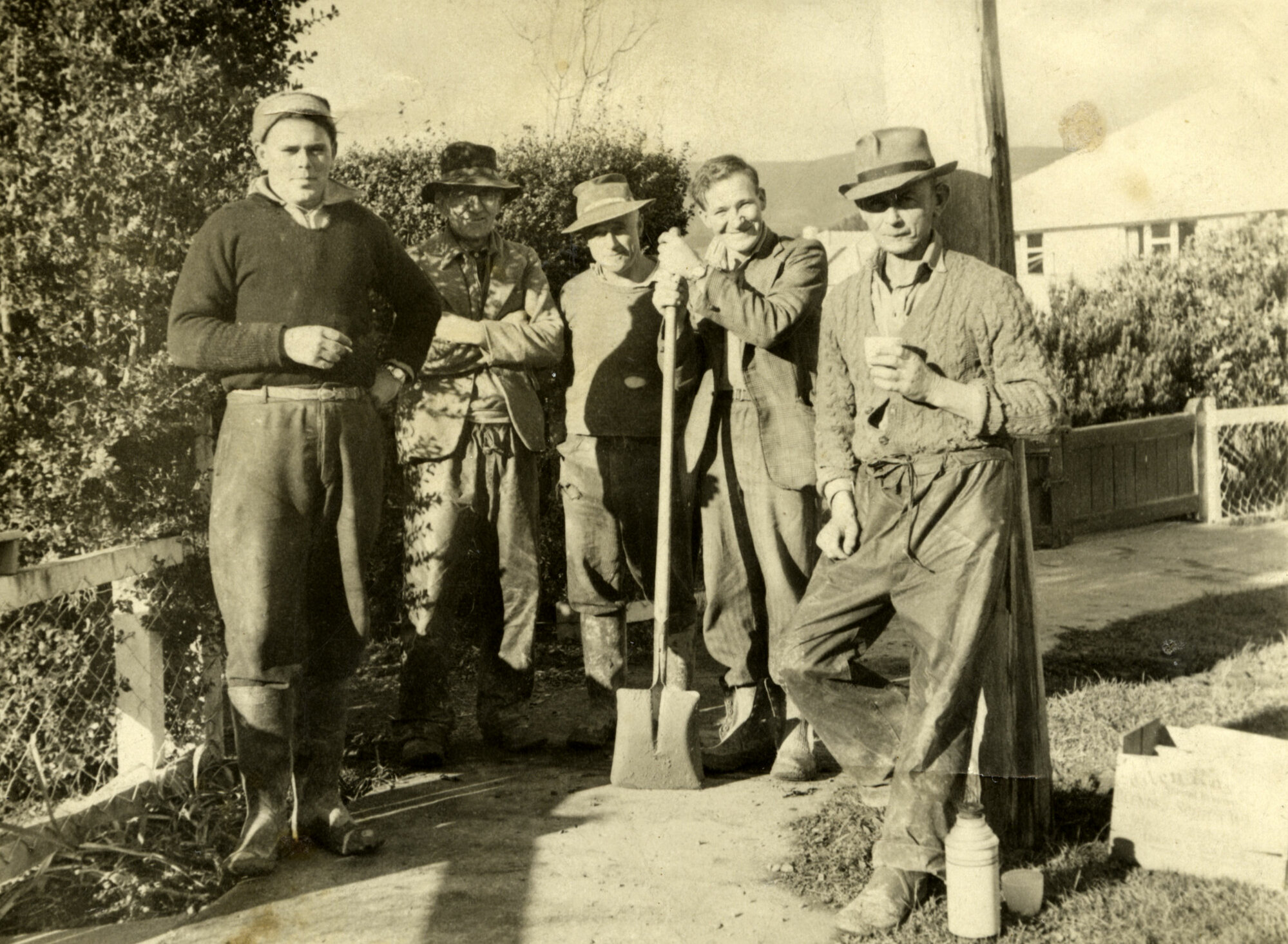 Men Standing on Footpath; ca 1940s
