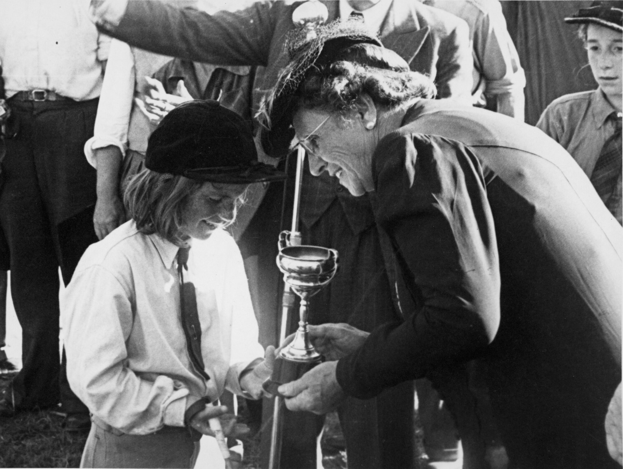 A &amp; P show; young riding competitor receiving cup.