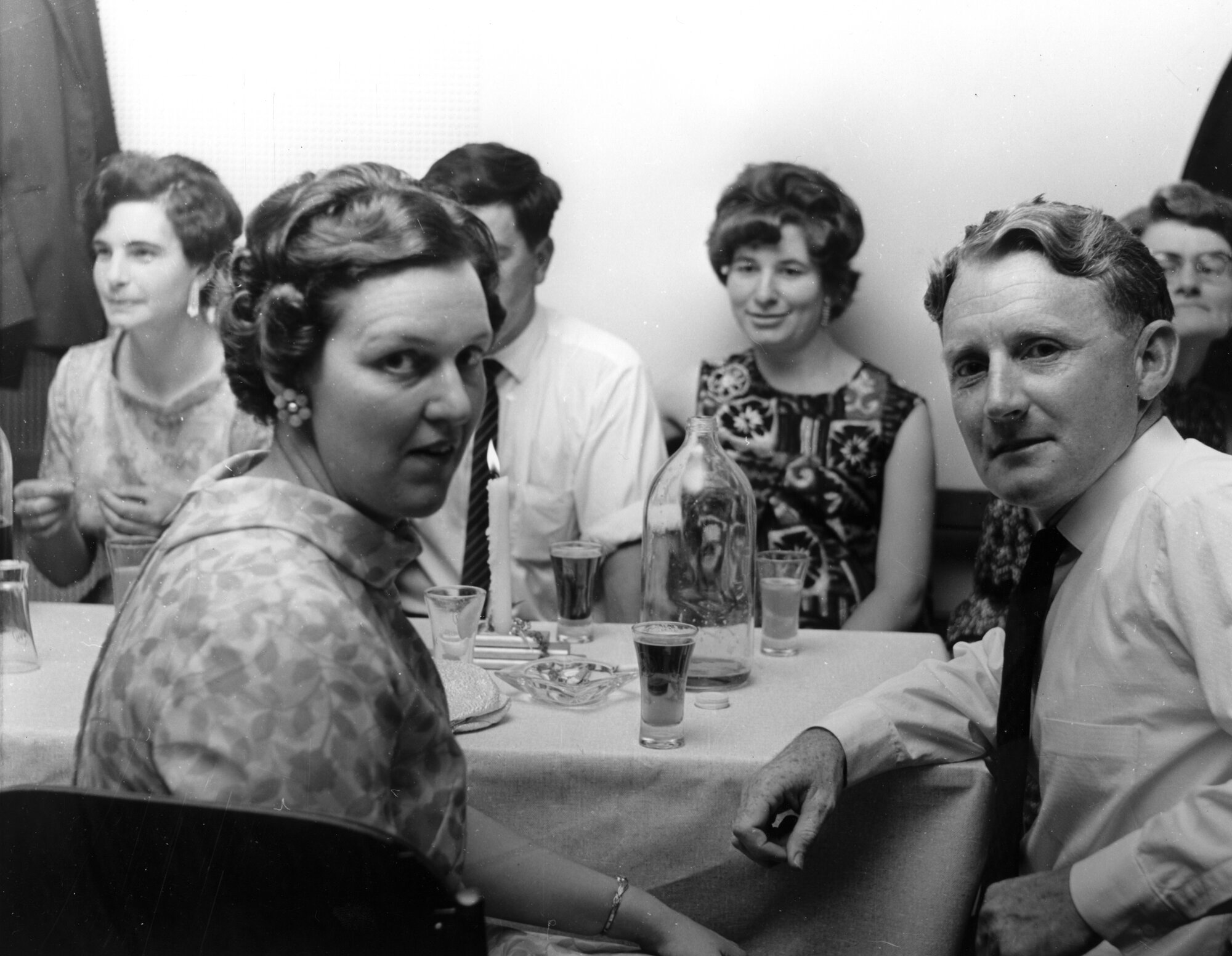 Social gathering, showing a classic NZ "half-G"; a half-gallon beer container.