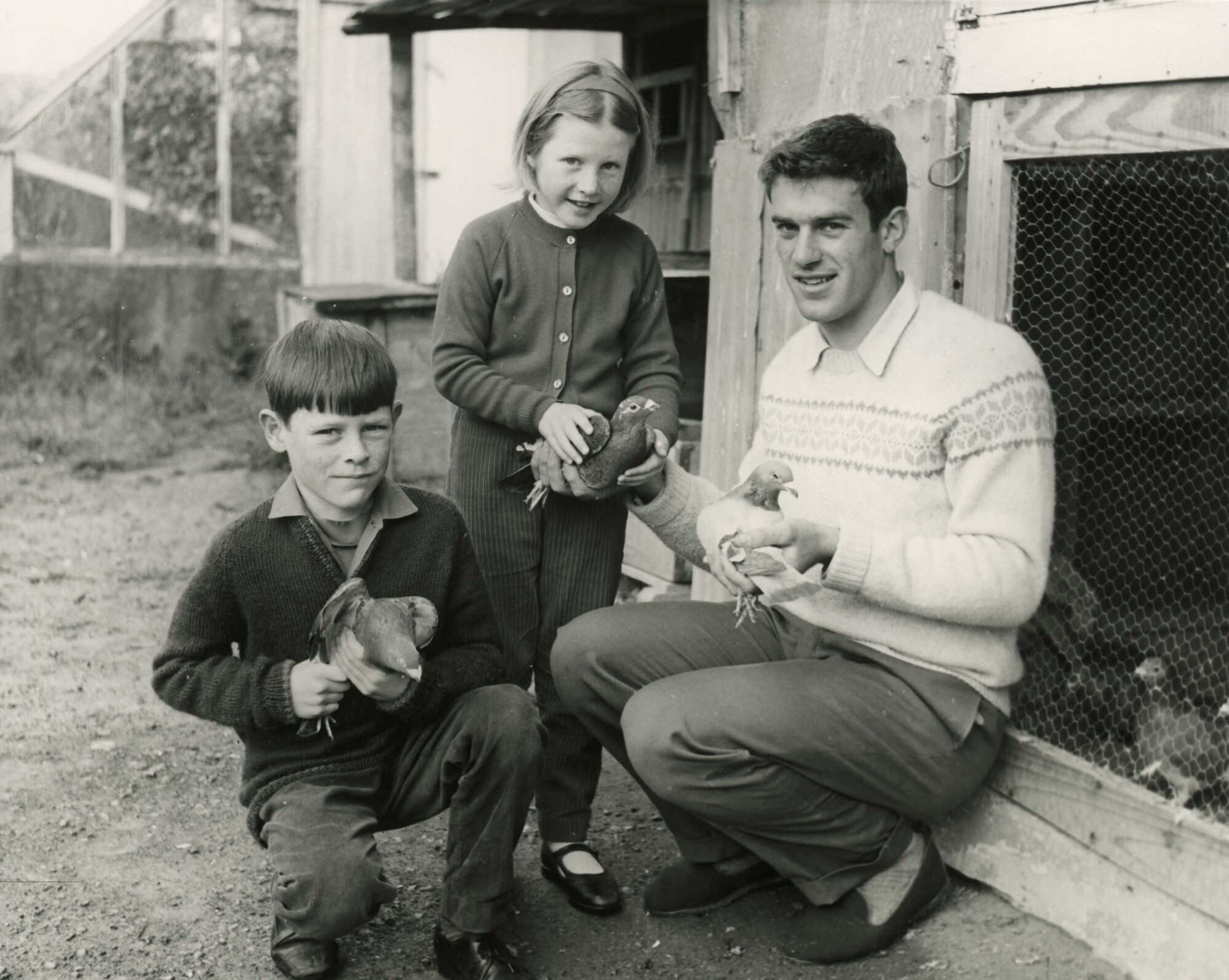 Harry Kent, cyclist (gold medal at Commonwealth Games, 1970) with children and pigeons.