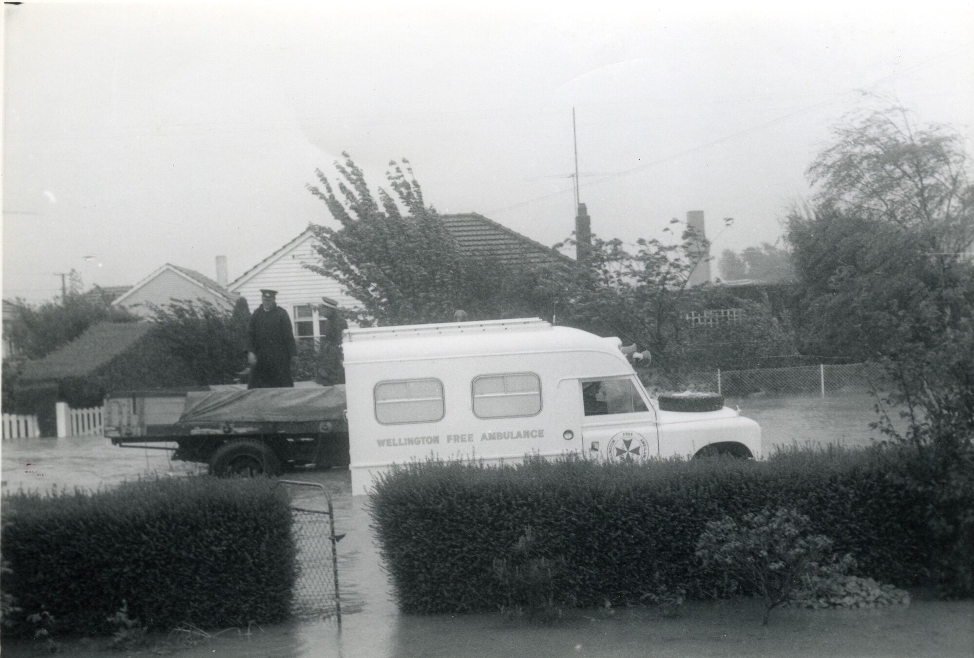 Flood, 1963; view from 32 Moonshine Road, with ambulance passing.