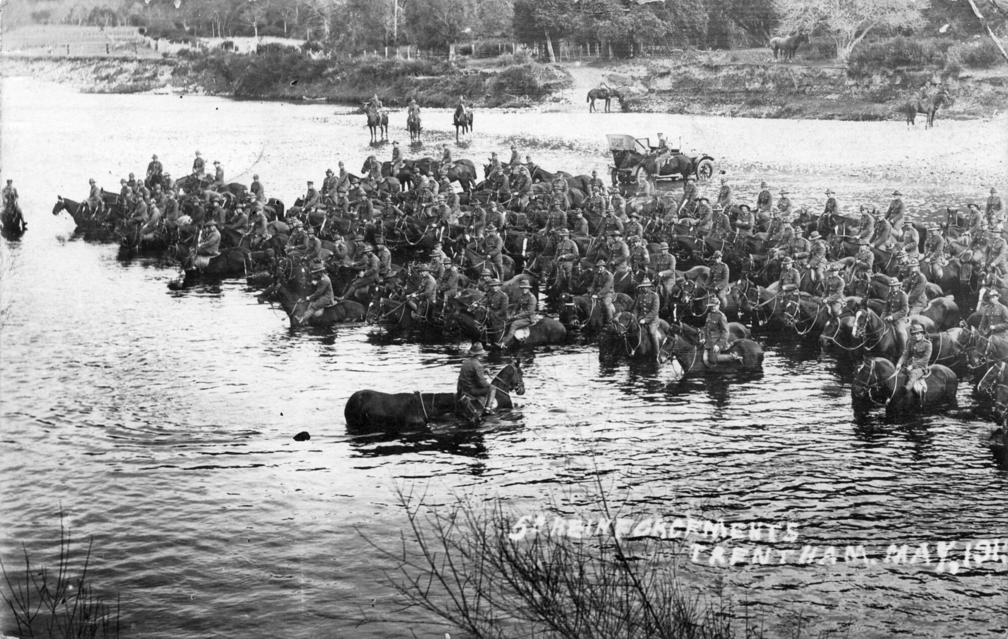 Soldiers on horseback in Te Awa Kairangi / Hutt River, Trentham.