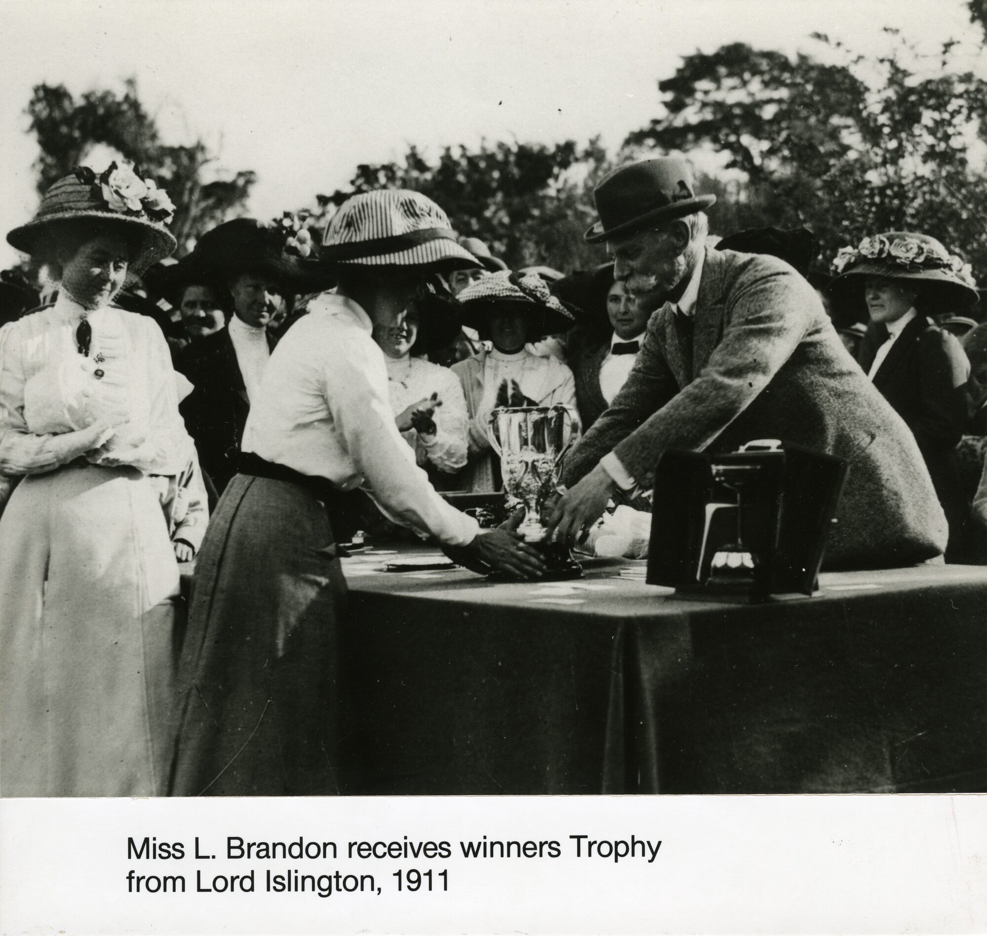 Trentham racecourse; Miss L. Brandon receives winner's trophy from the Governor-General, Lord Islington. [P3-554-3278]