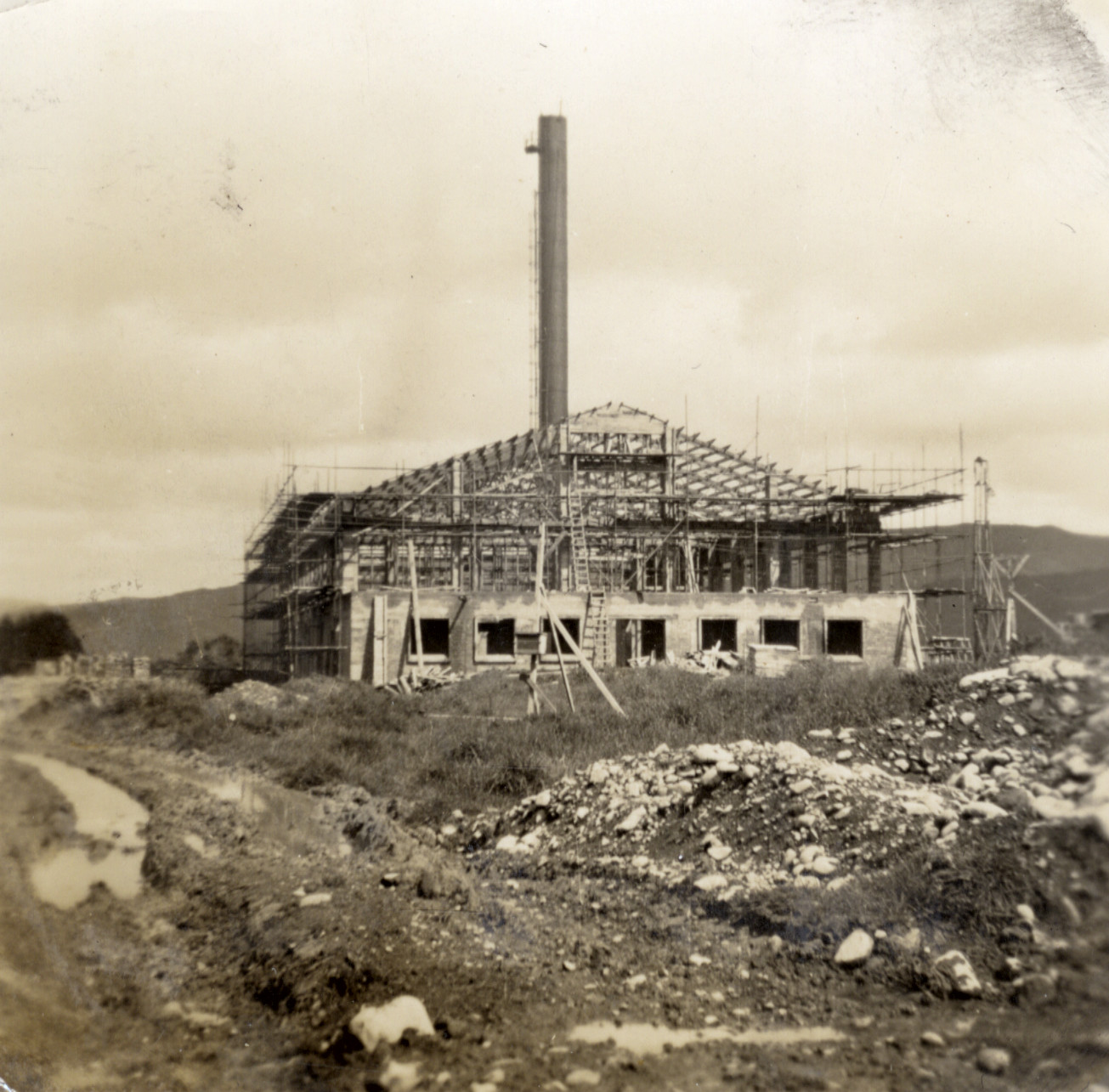 Dunlop factory building construction; boiler-house from the east; chimney nearing completion.