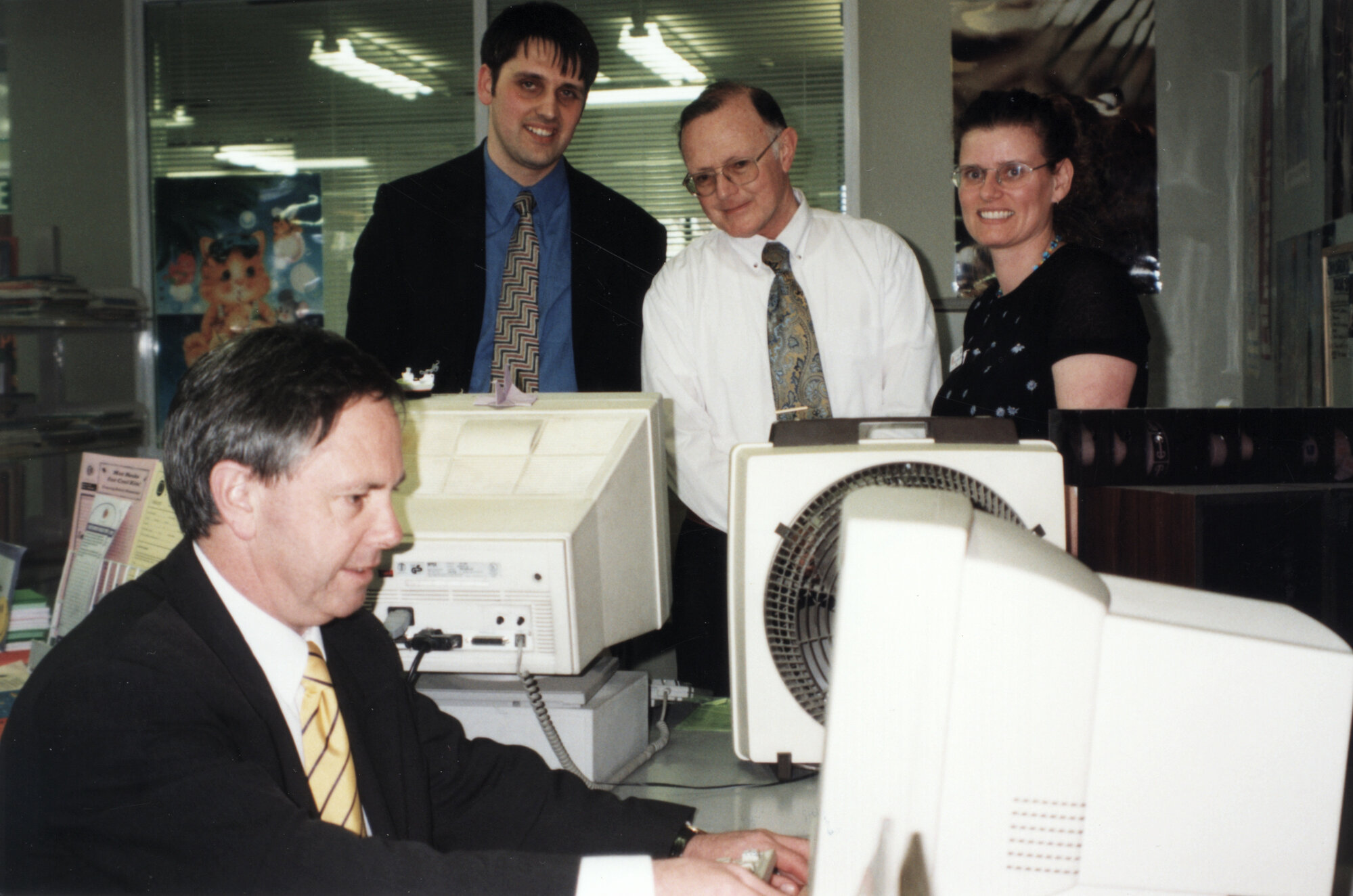 Library; Paul Swain, Minister of Information Technology, at a public-use computer terminal.
