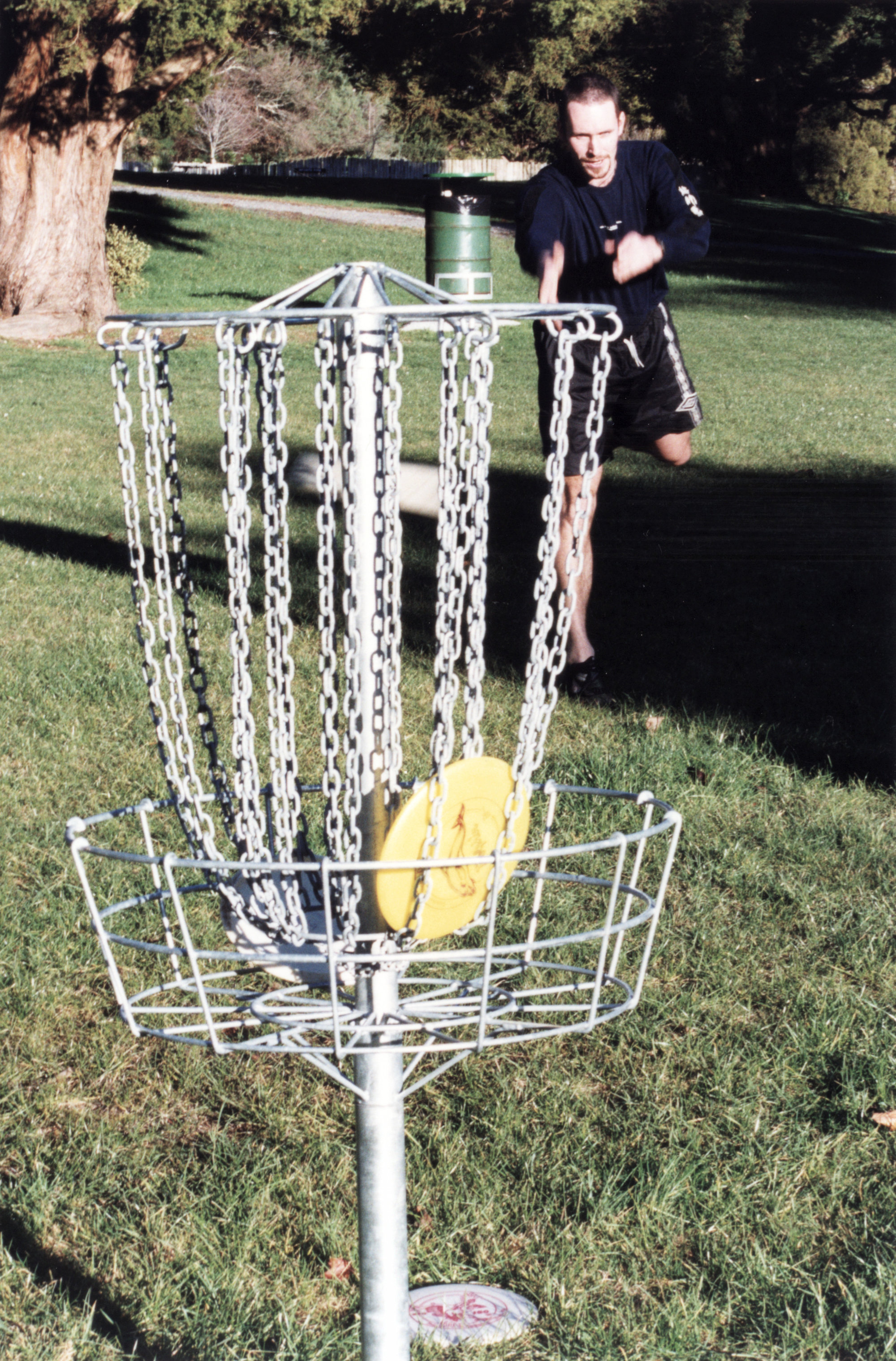 Harcourt Park; Arthur Pengelly and disc golf equipment;  a 'hole', designed to catch frisbees.