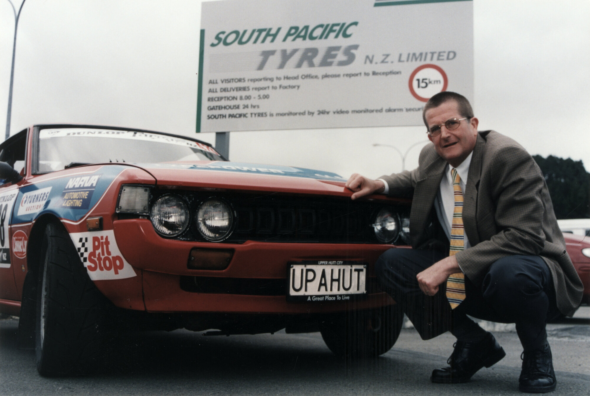 Dunlop Targa rally; Alan Moore's Toyota Celica with promotional plate and mayor Wayne Guppy.