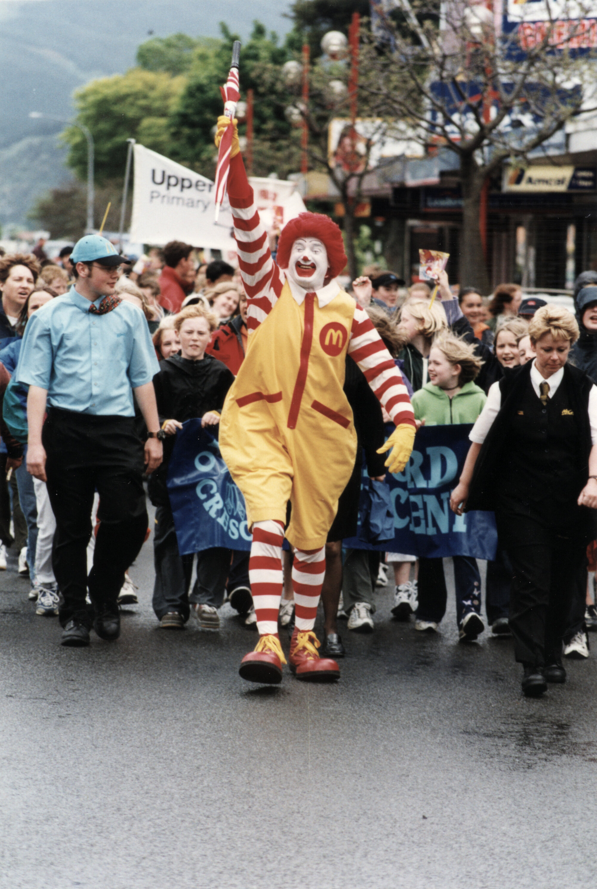 School crossing children's parade 2002 in Main Street, with 'Ronald McDonald'.