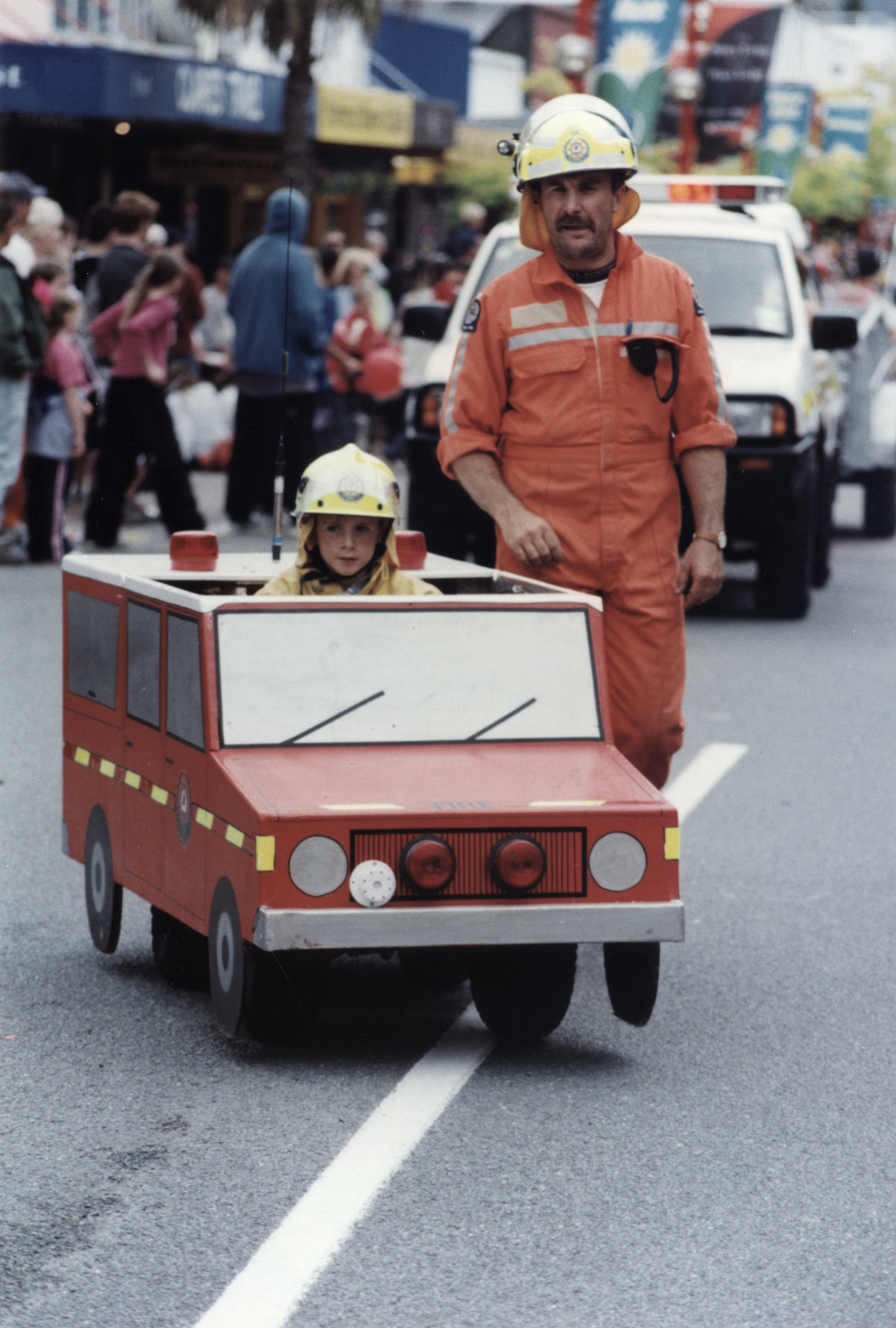 Christmas parade 2003; small fire engine and fireman, with Dad; unnamed.
