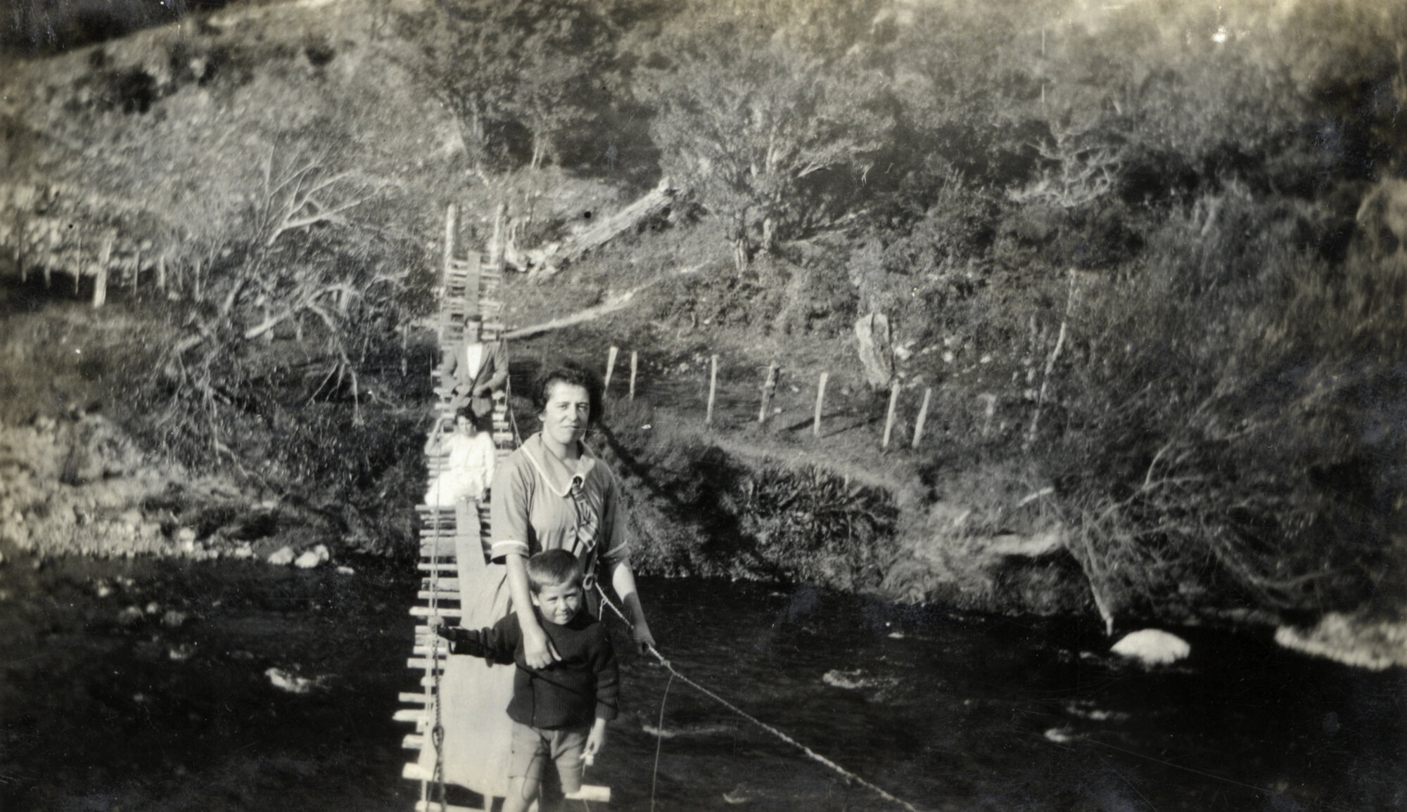 Poulson family; Hec, Esther, Alma, Tom, nearest (on the Poulsons' suspension bridge, Akatarawa?)
