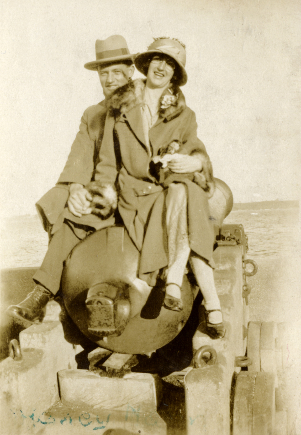 Poulson family; Hector and May Poulson sitting on a cannon 