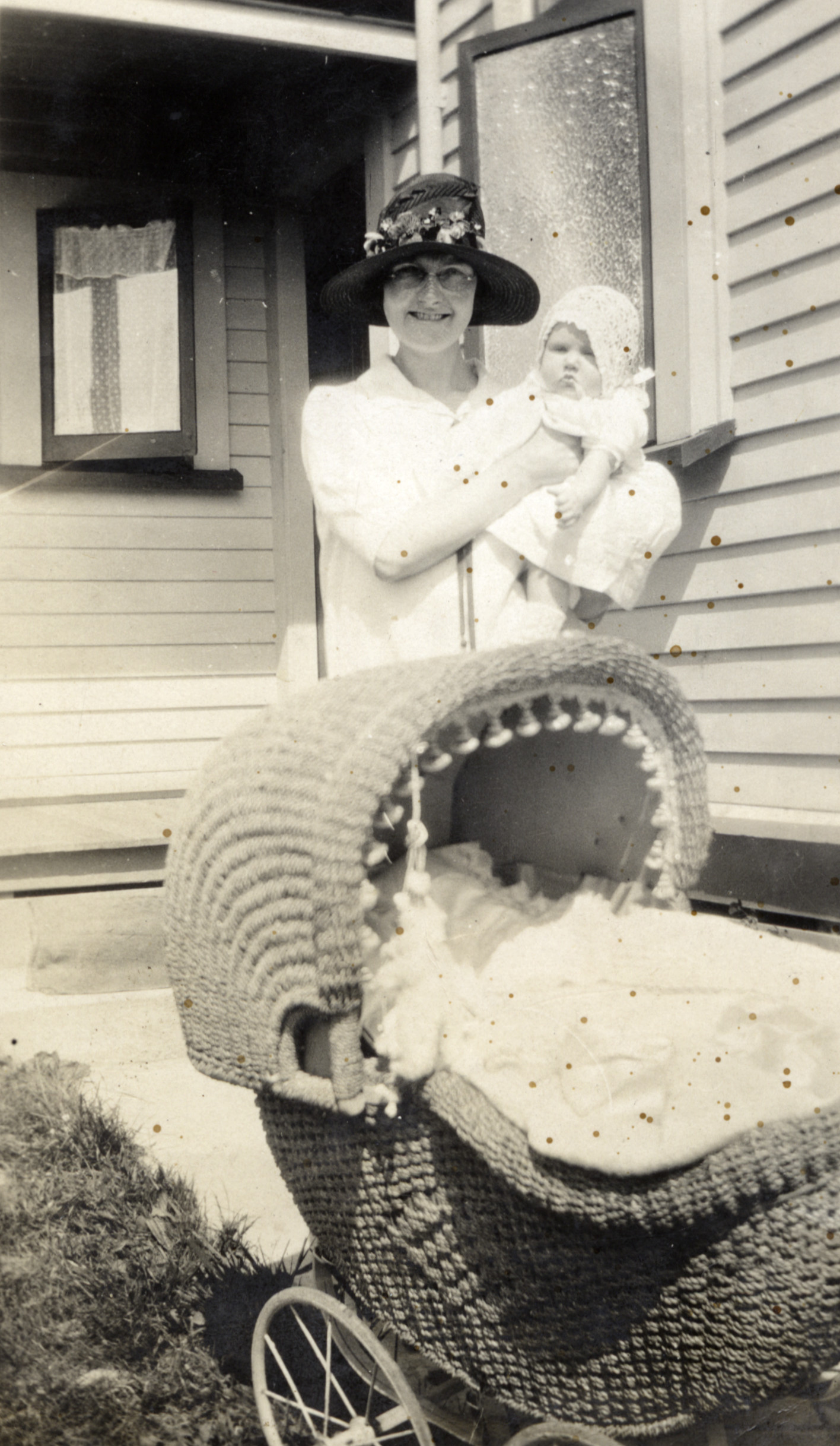 Poulson family; unidentified woman holding Hector and May's daughter Eda