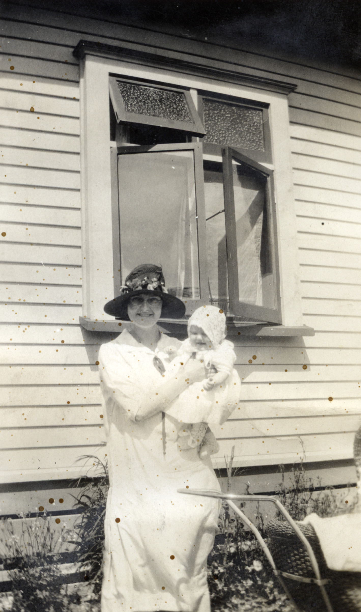 Poulson family; unidentified woman holding Hector and May's daughter Eda