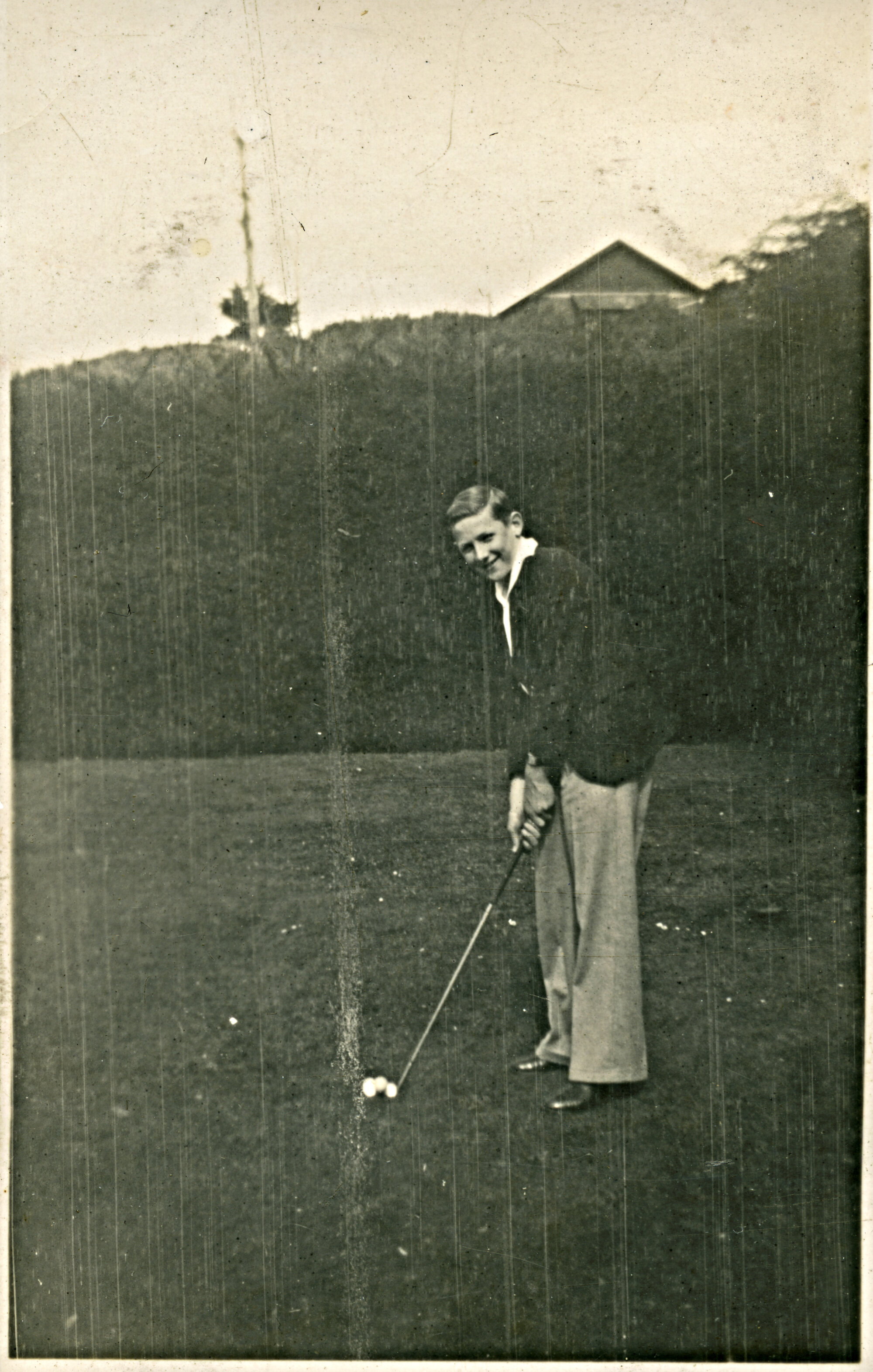 Man with golf club, 1930s