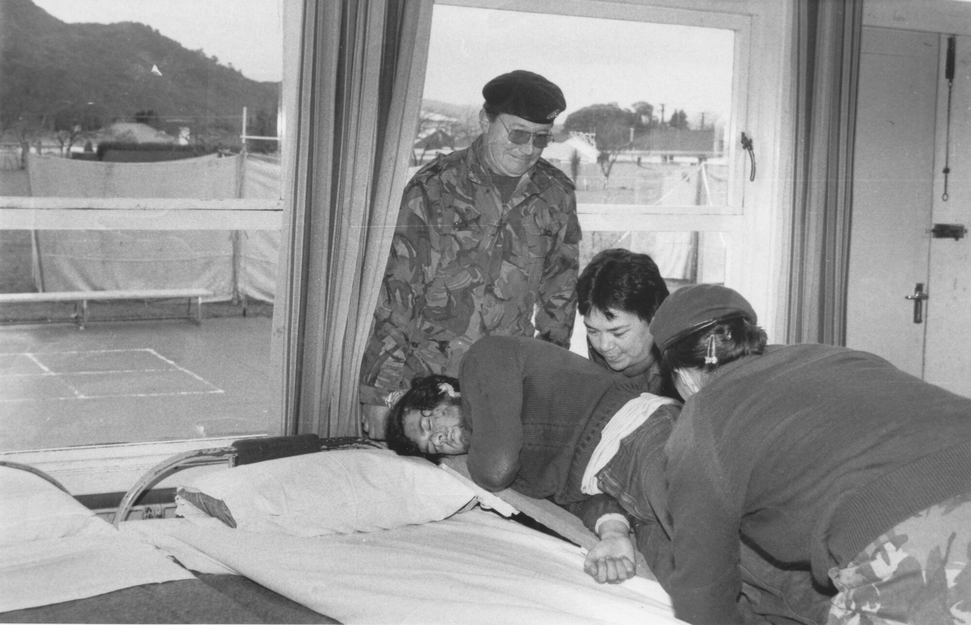 Civil Defence simulated-earthquake exercise; with Army and Red Cross; moving casualty from stretcher to bed, Fraser Crescent School.