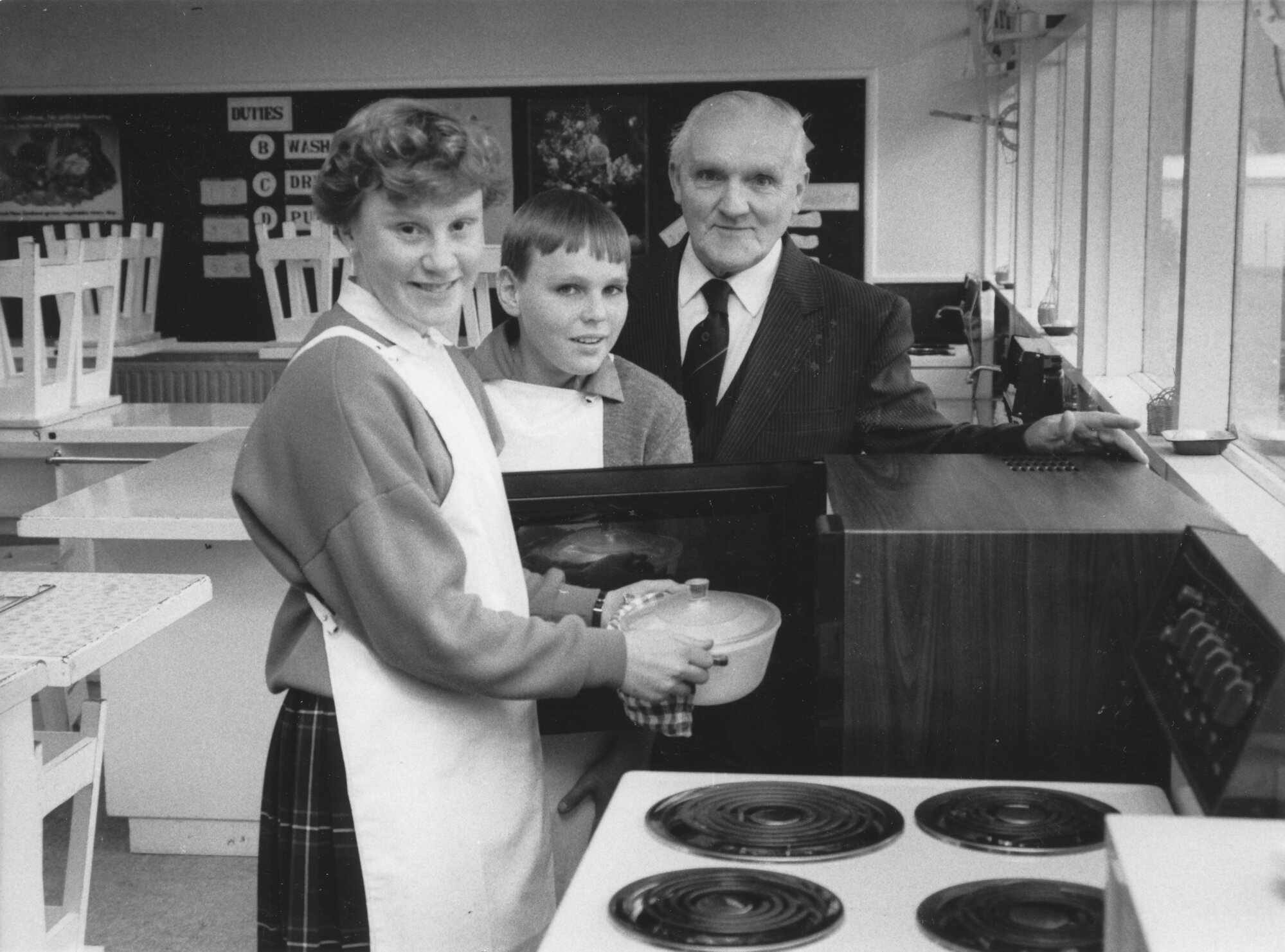Fergusson Intermediate's first microwave cooker; Louise Hall, Carrigan Smith, Fred Charles.