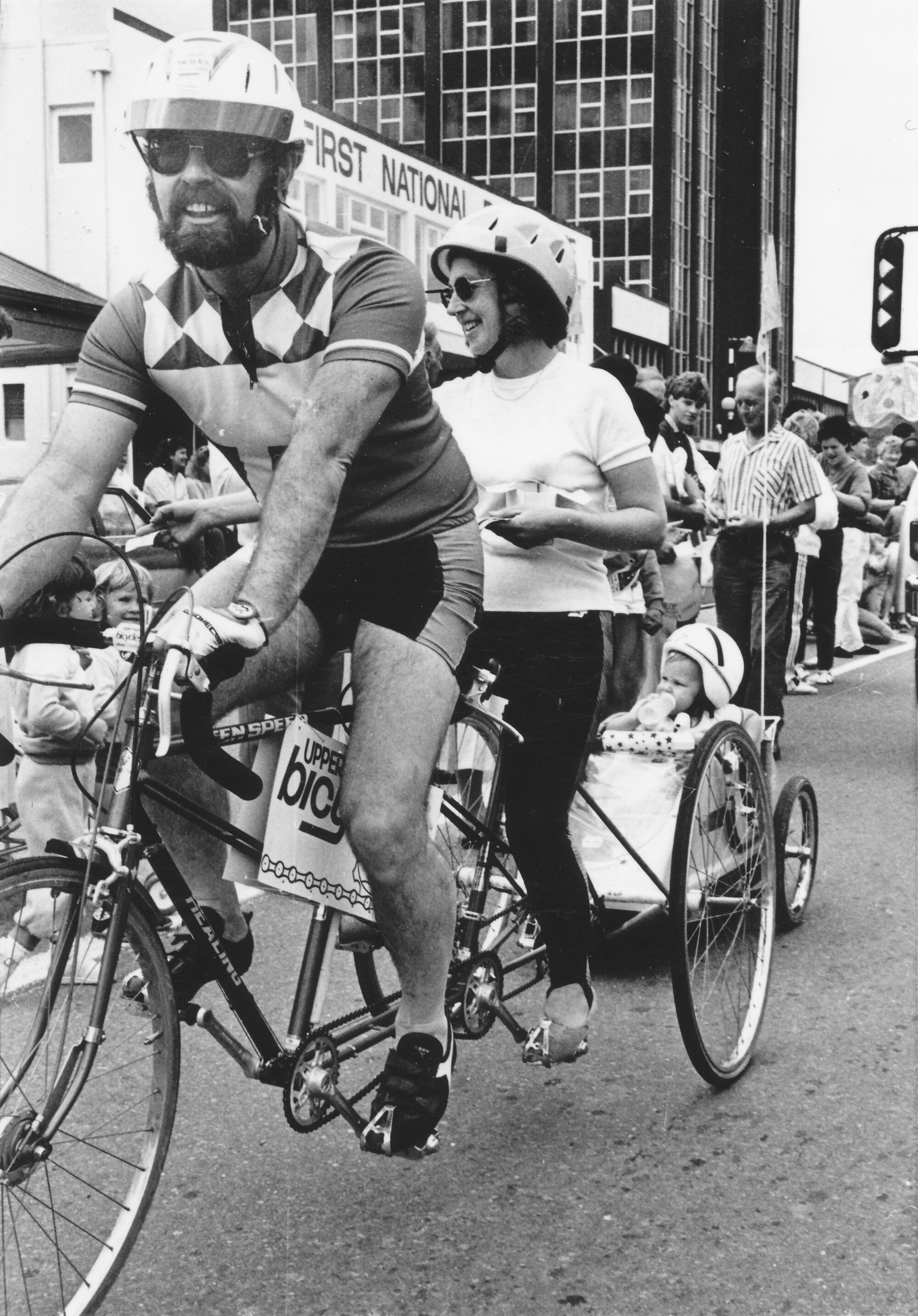 Christmas parade 1987; David Butler and Sheila Radcliffe on tandem tricycle with son Chase in trailer.