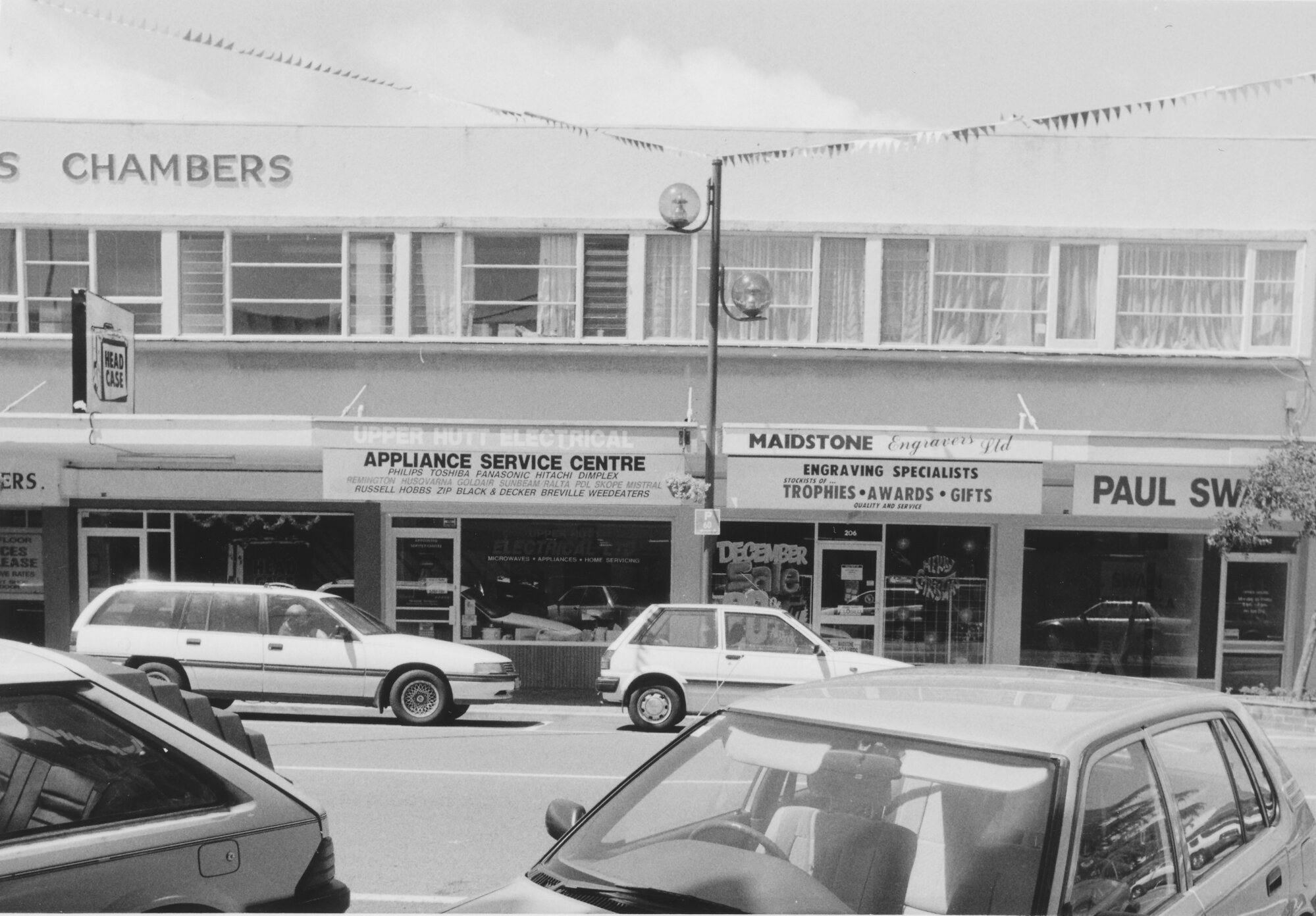 Main Street, 1997, south side; No. 204-212; Head Case (210); Upper Hutt Electrical (208); Maidstone Engravers (206); Labour electorate office (204), Paul Swain, M P.