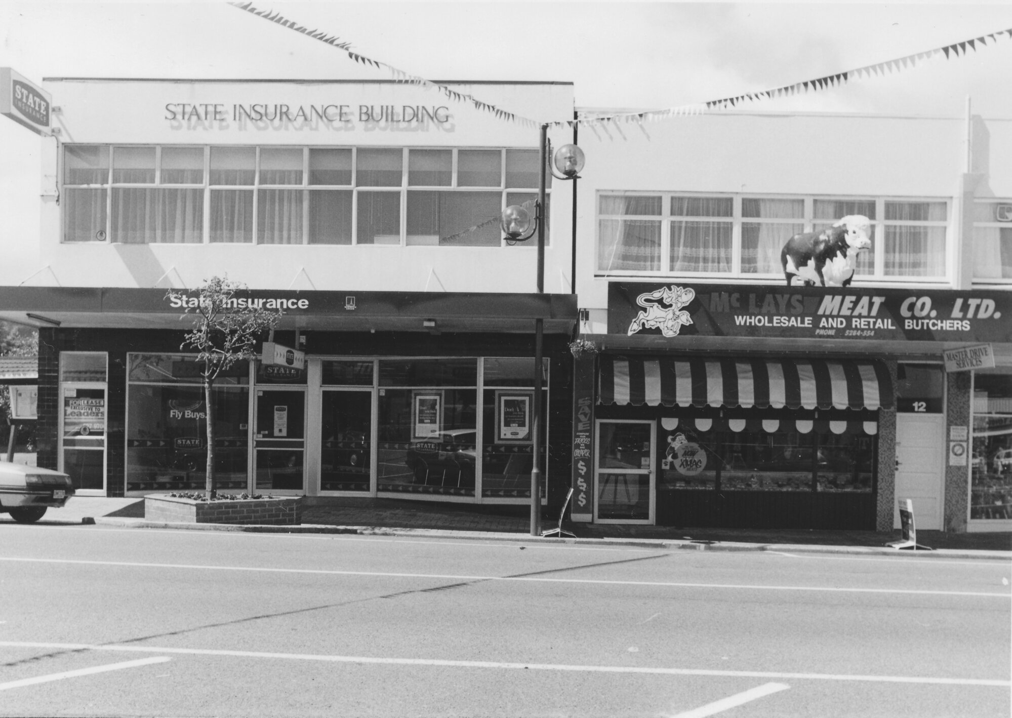 Main Street, 1997, south side; No.  14-16; State Insurance(16) and McLays  Meat Co, Ltd. (14)