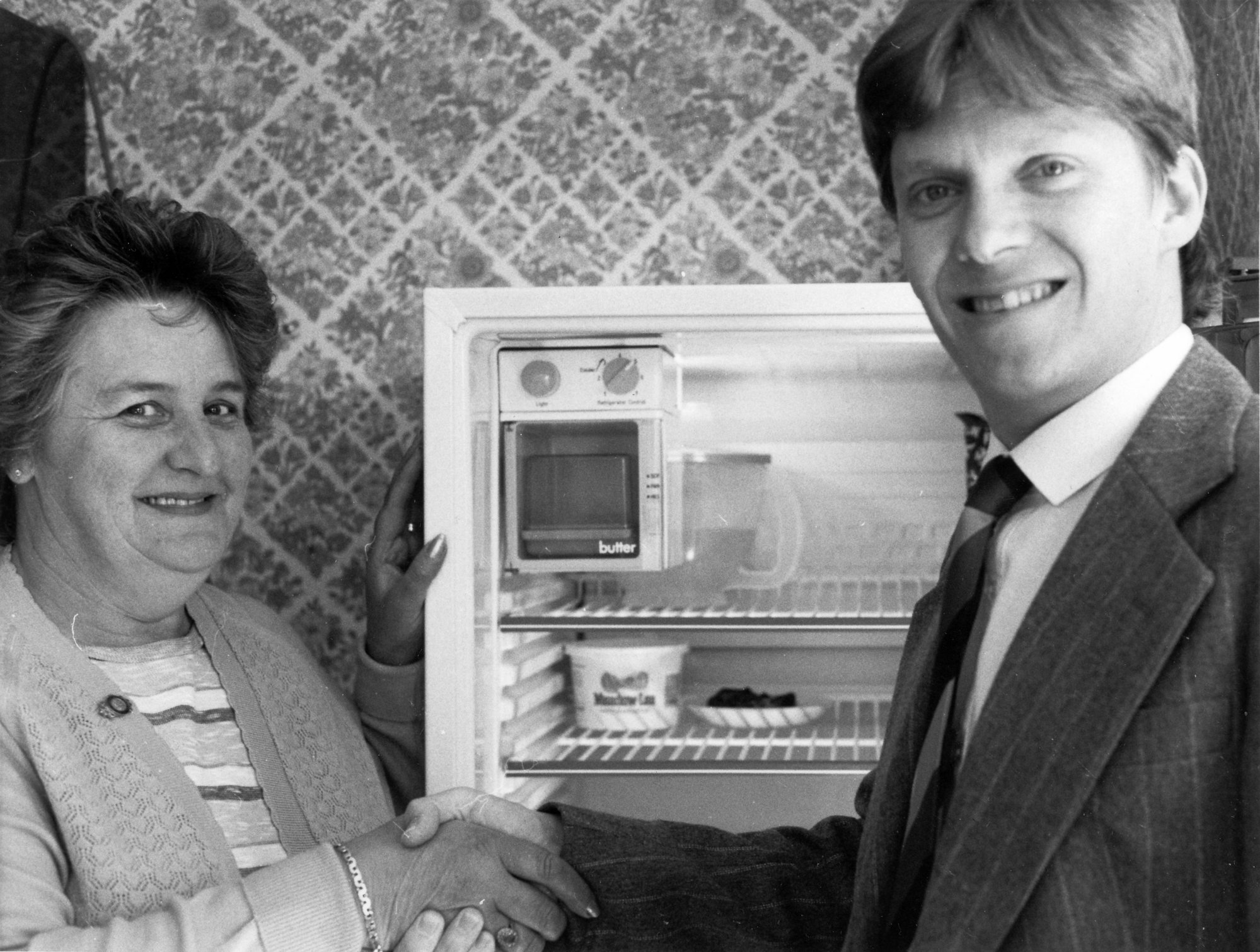 Shirley  Russell receiving refrigerator/freezer donated to Red Cross by Smith and Brown; with their manager Richard Murphy.