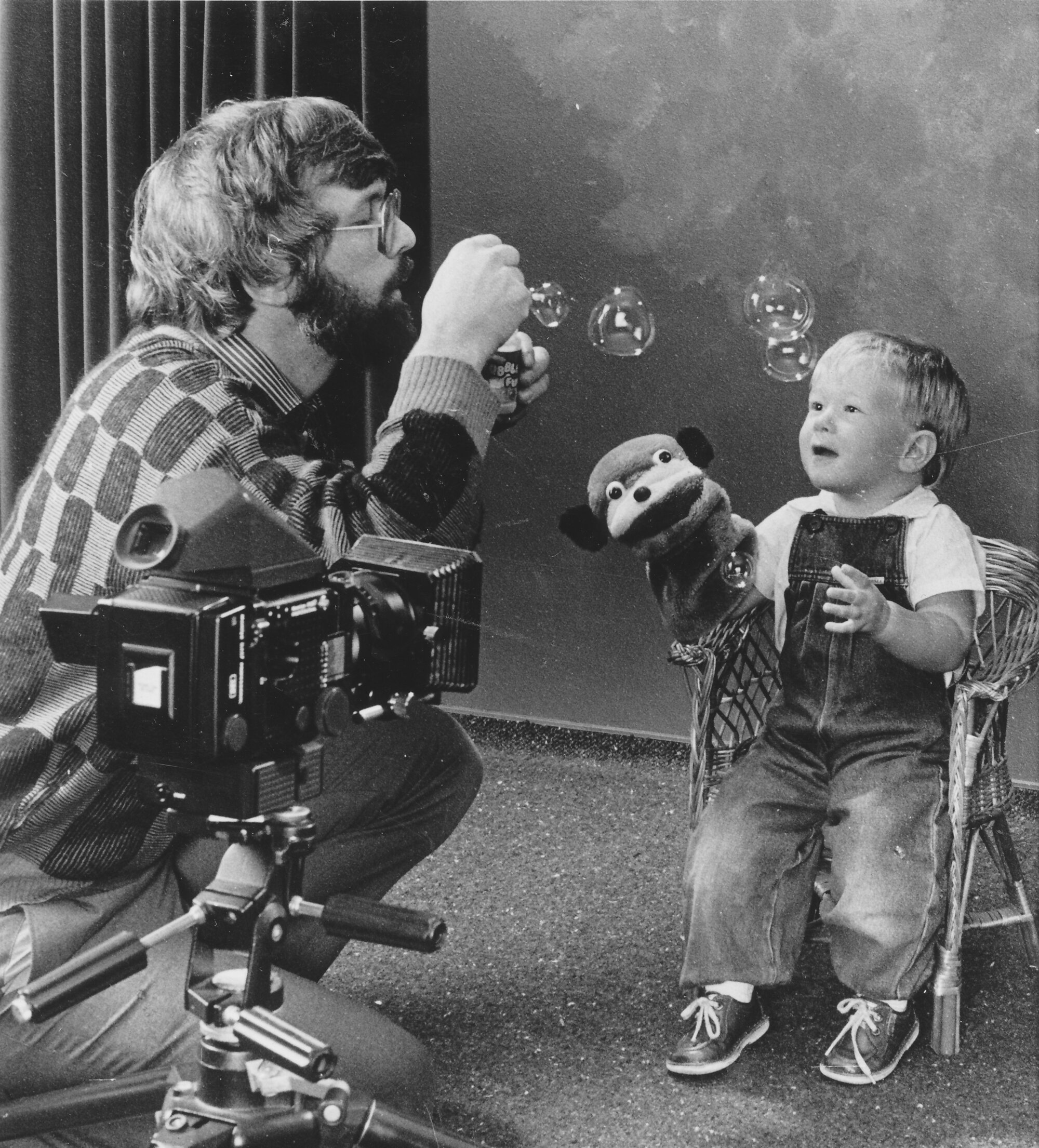Andrew Chaplow  photographing Hamish Cain, 2, for a Plunket infant photo competition.