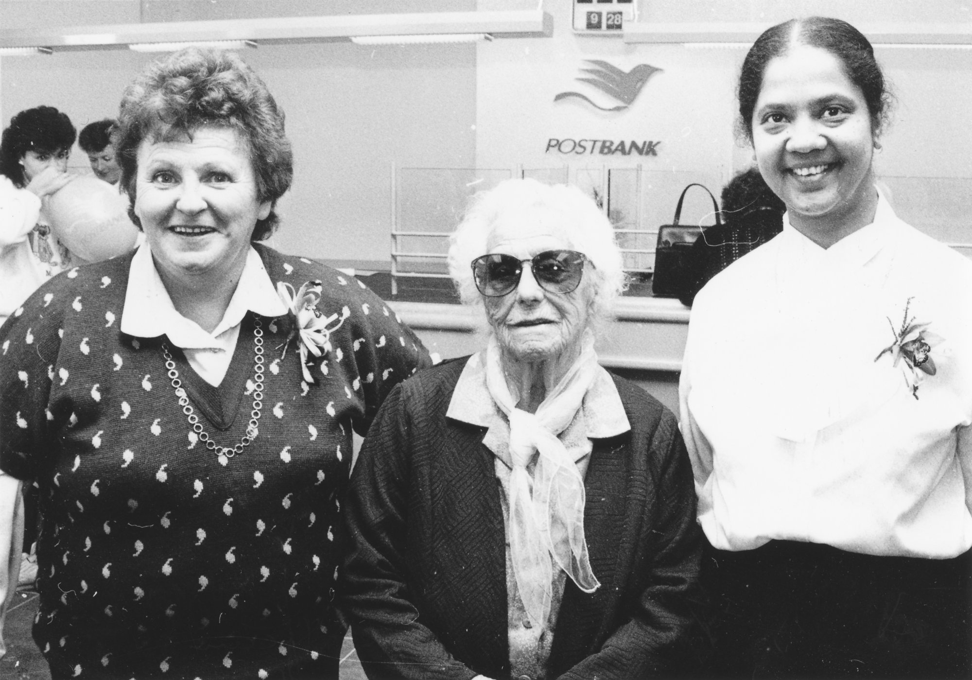 Postbank, Silverstream; tellers Norma Webby and Jai Kemp with Katherine Shaw, 93, in new Kiln Street premises.