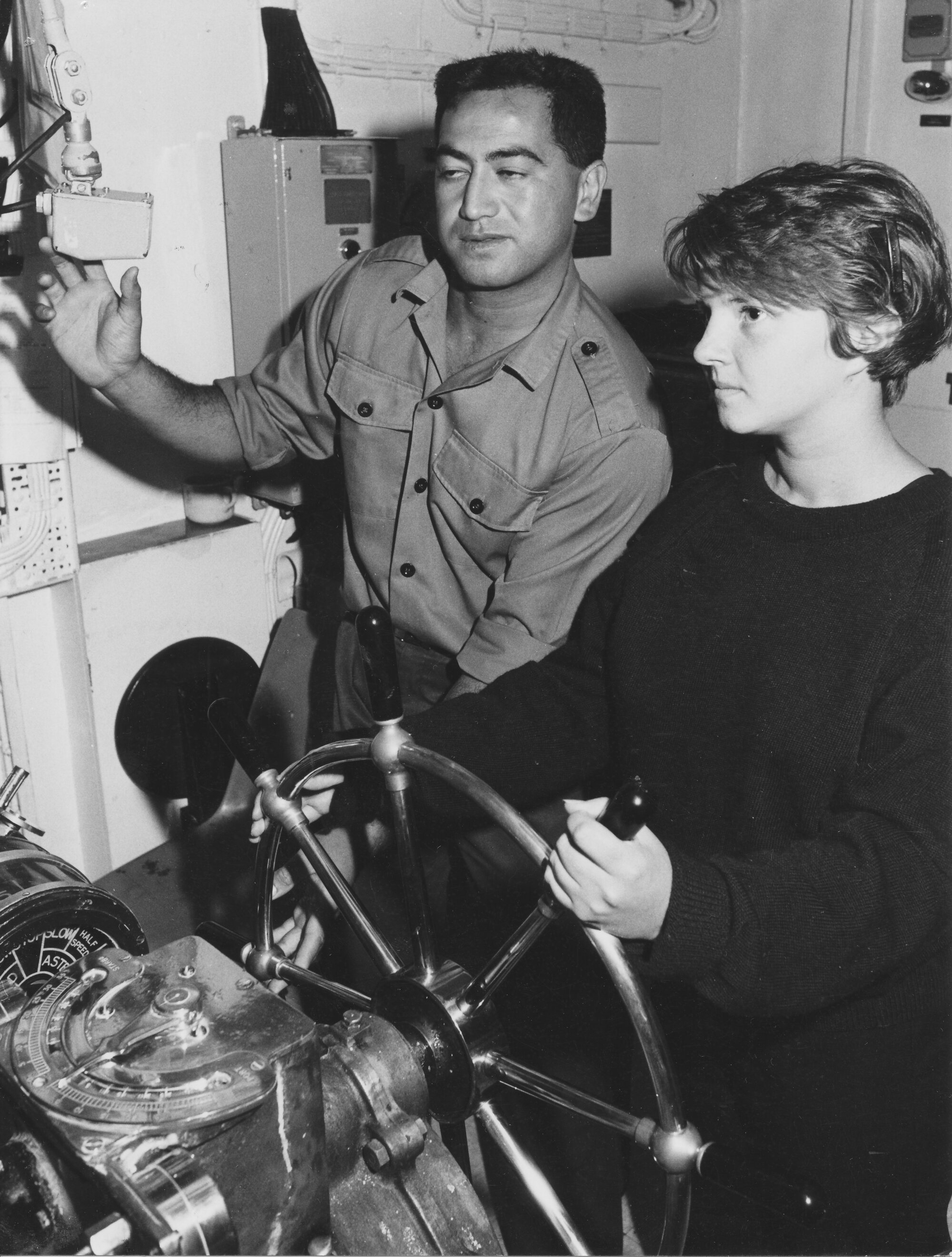 Navy; Sea Cadet Alison Rodgers at the wheel of frigate HMNZS Southland, with Able Seaman Barry Waerea.