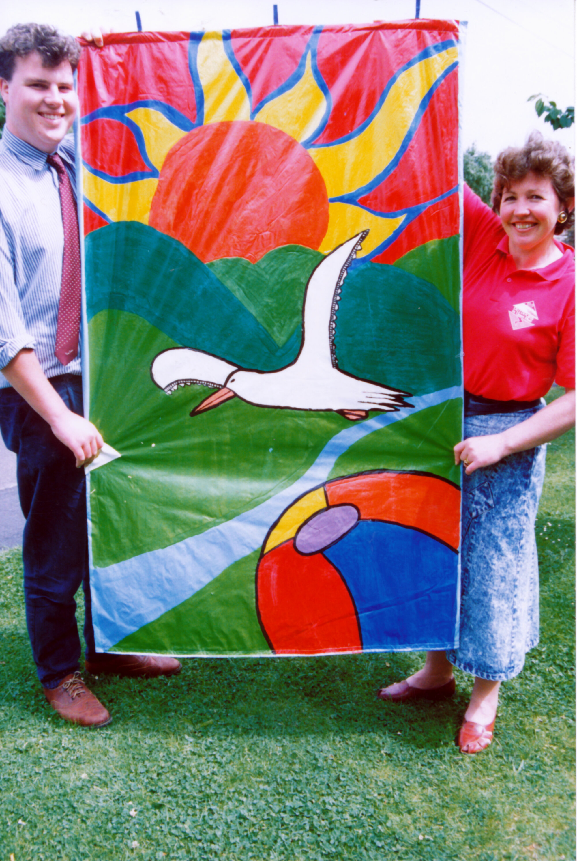 Community liaison staff with summer banner by Heretaunga College