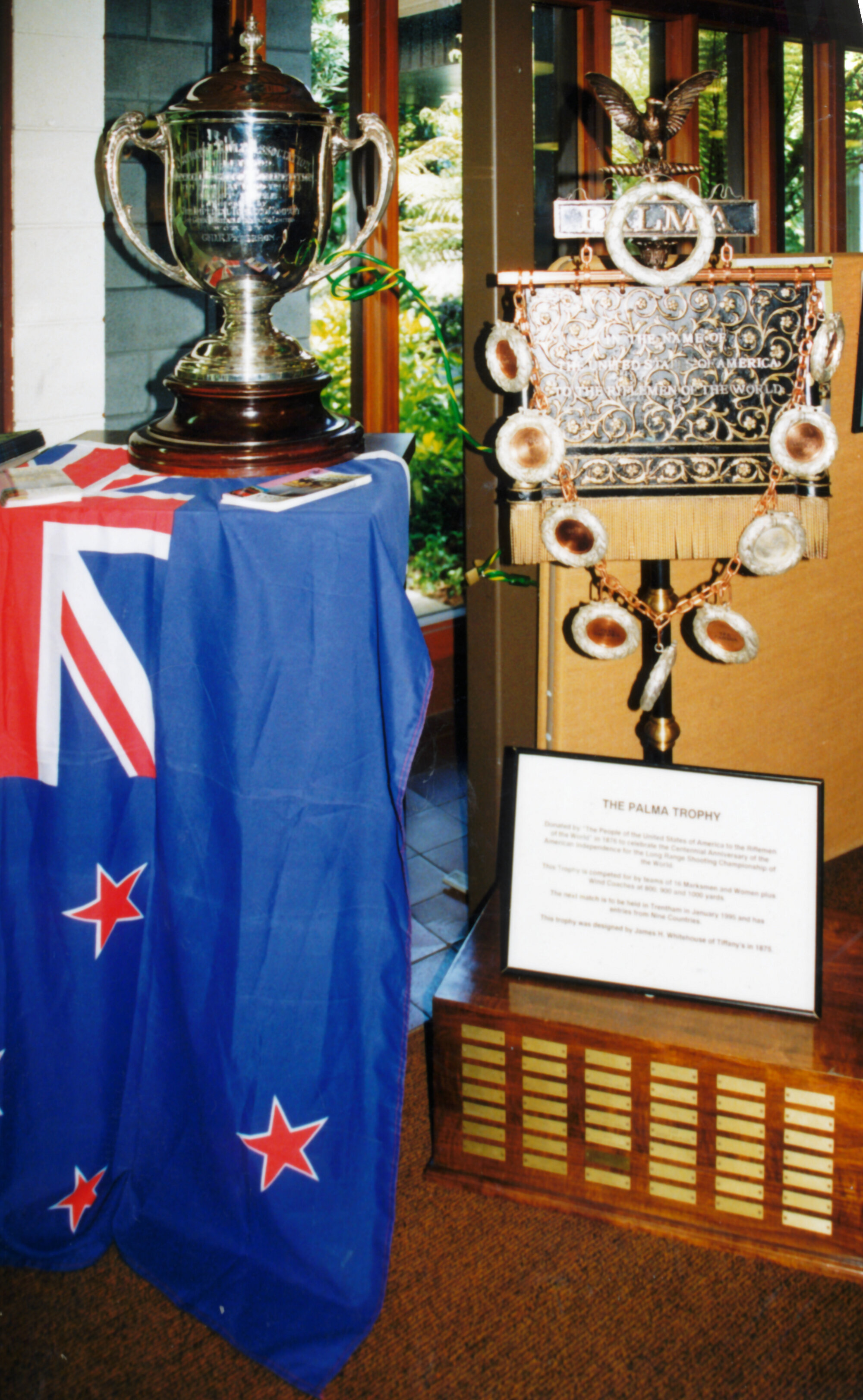 Rifle shooting; Bisley Cup and Palma Trophy displayed in the public library.