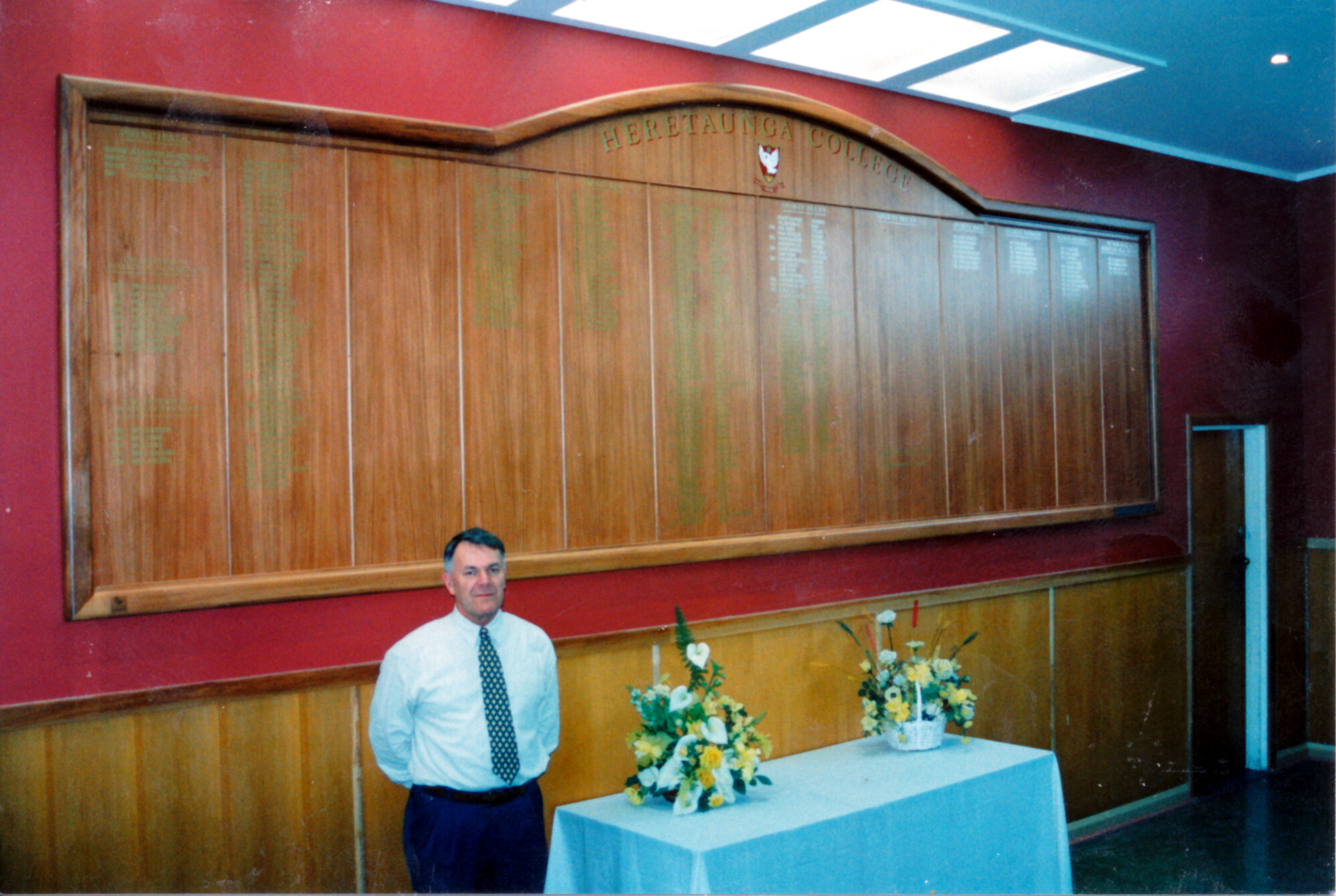 Heretaunga College buldings; principal Brian Robb with new honours board from reunion funds.