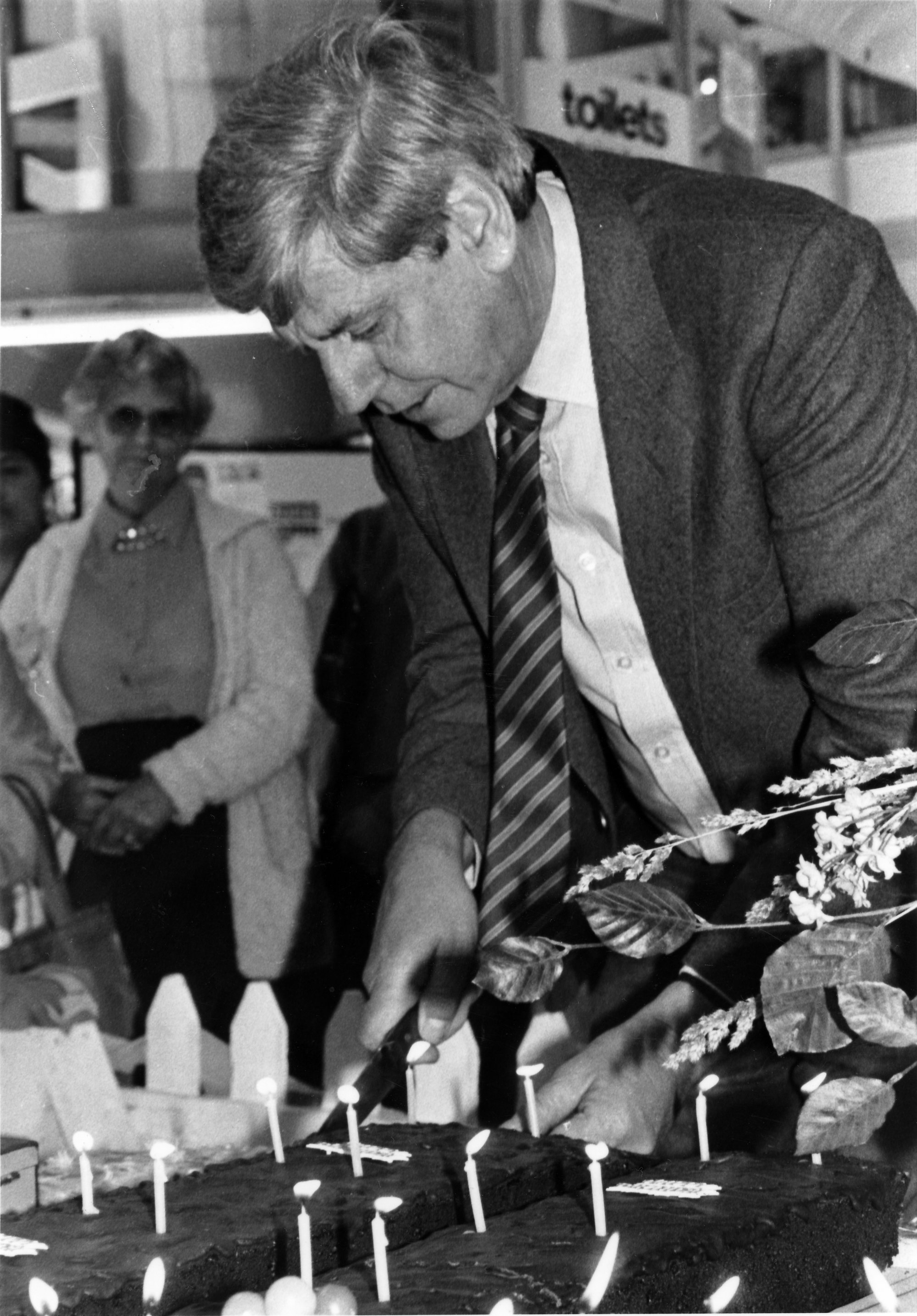 Maidstone Mall; promotions manager Murray Hunt cuts one of three fourteenth-birthday cakes.