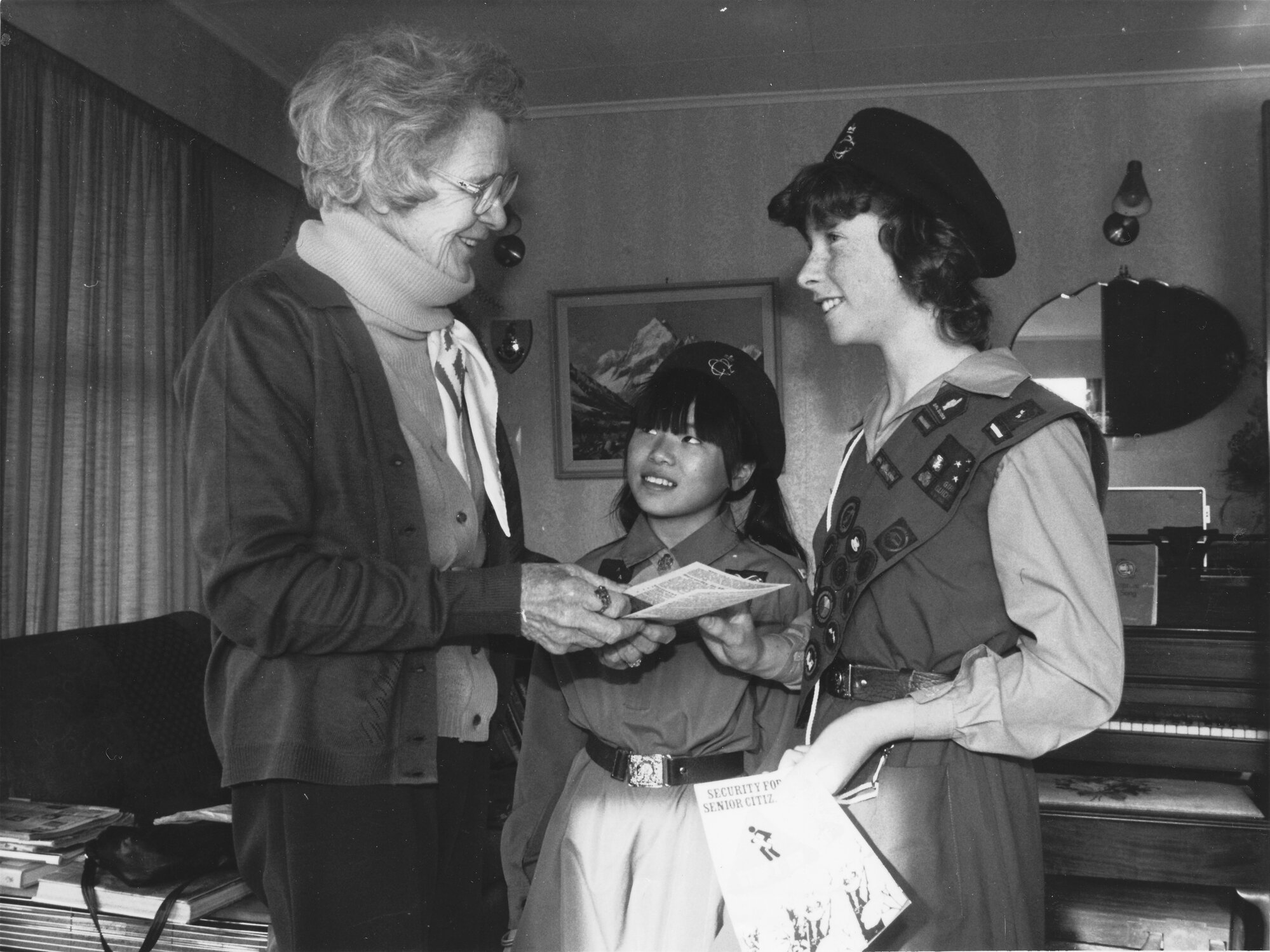 Girl Guides distributing their services directories and Police security leaflets to senior citizens.