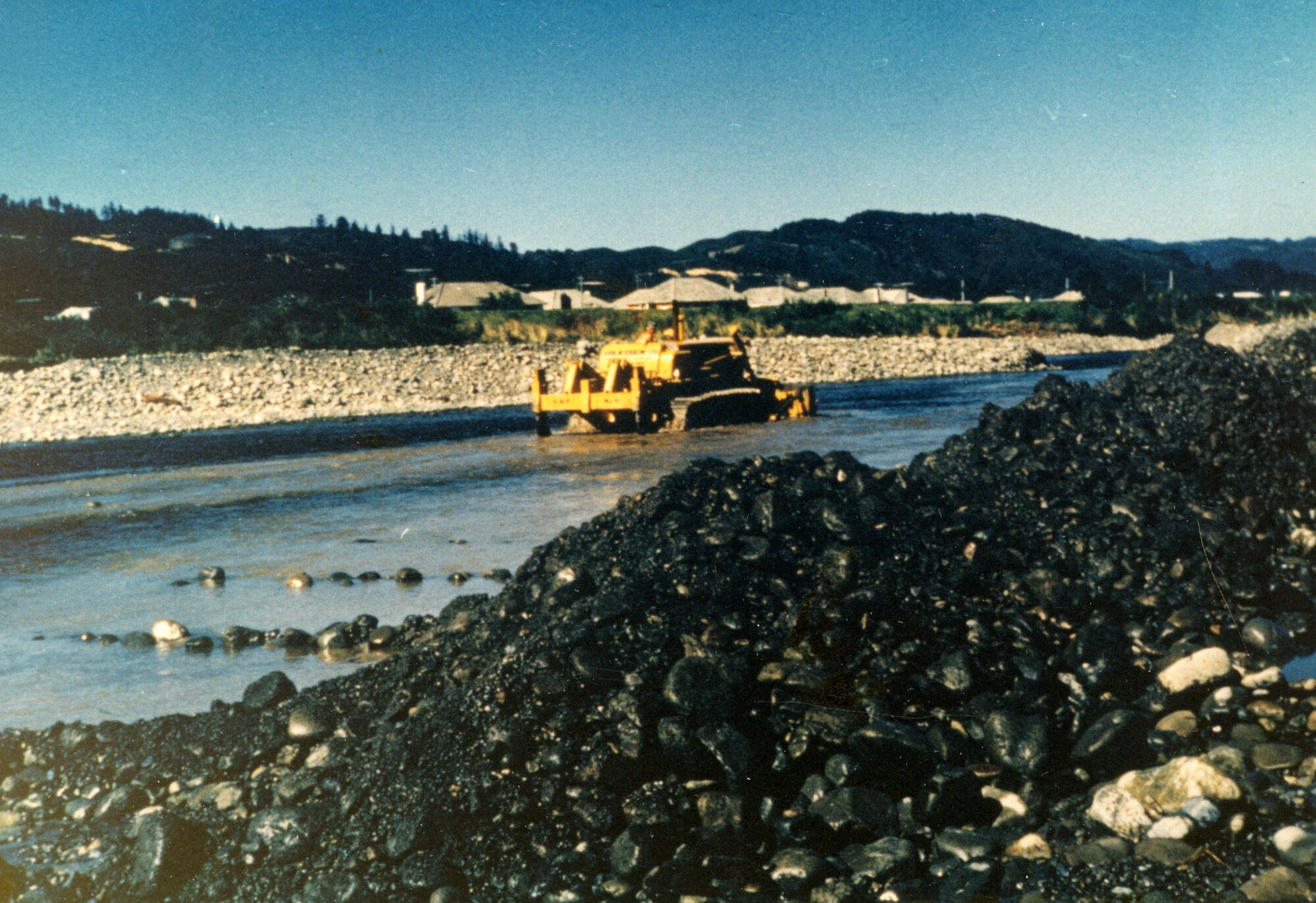Totara Park Bridge site; bulldozer and ripper excavating Te Awa Kairangi / Hutt River.