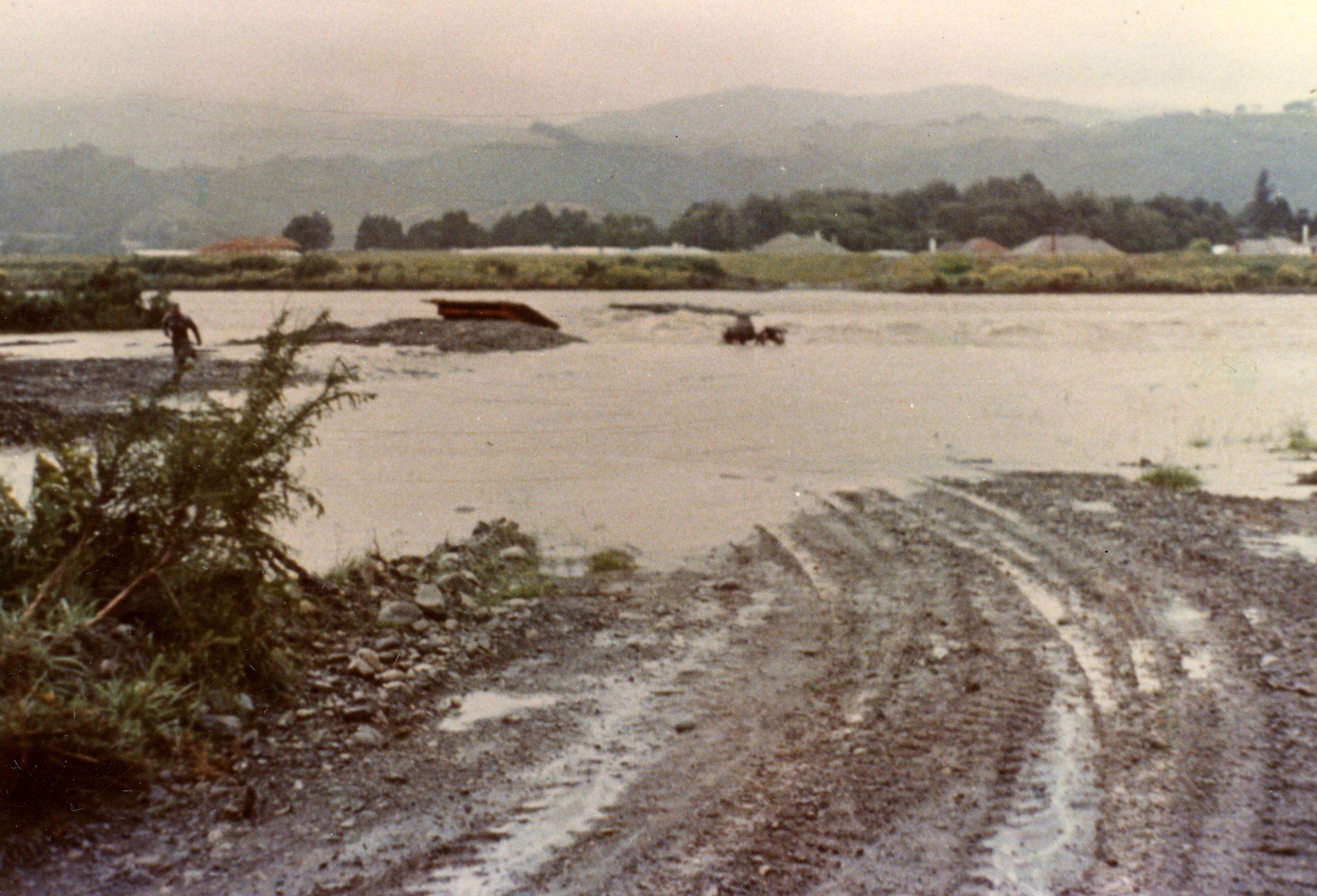 Totara Park bridge site; river in flood.