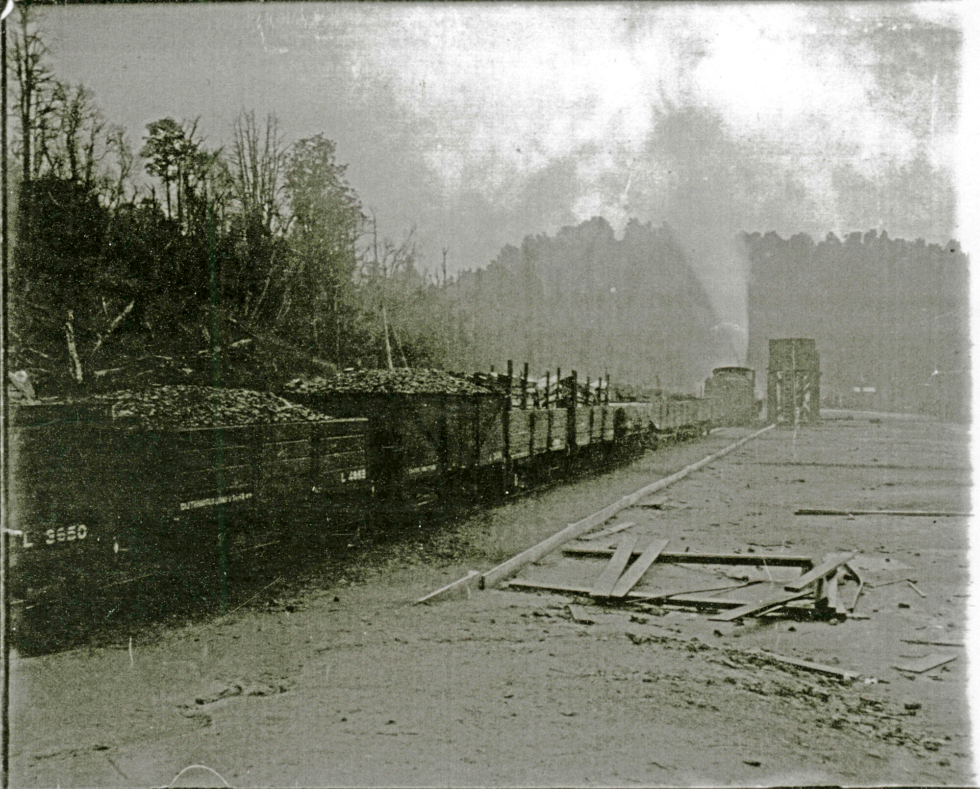 Railway yard showing wagons loaded with coal and wood
