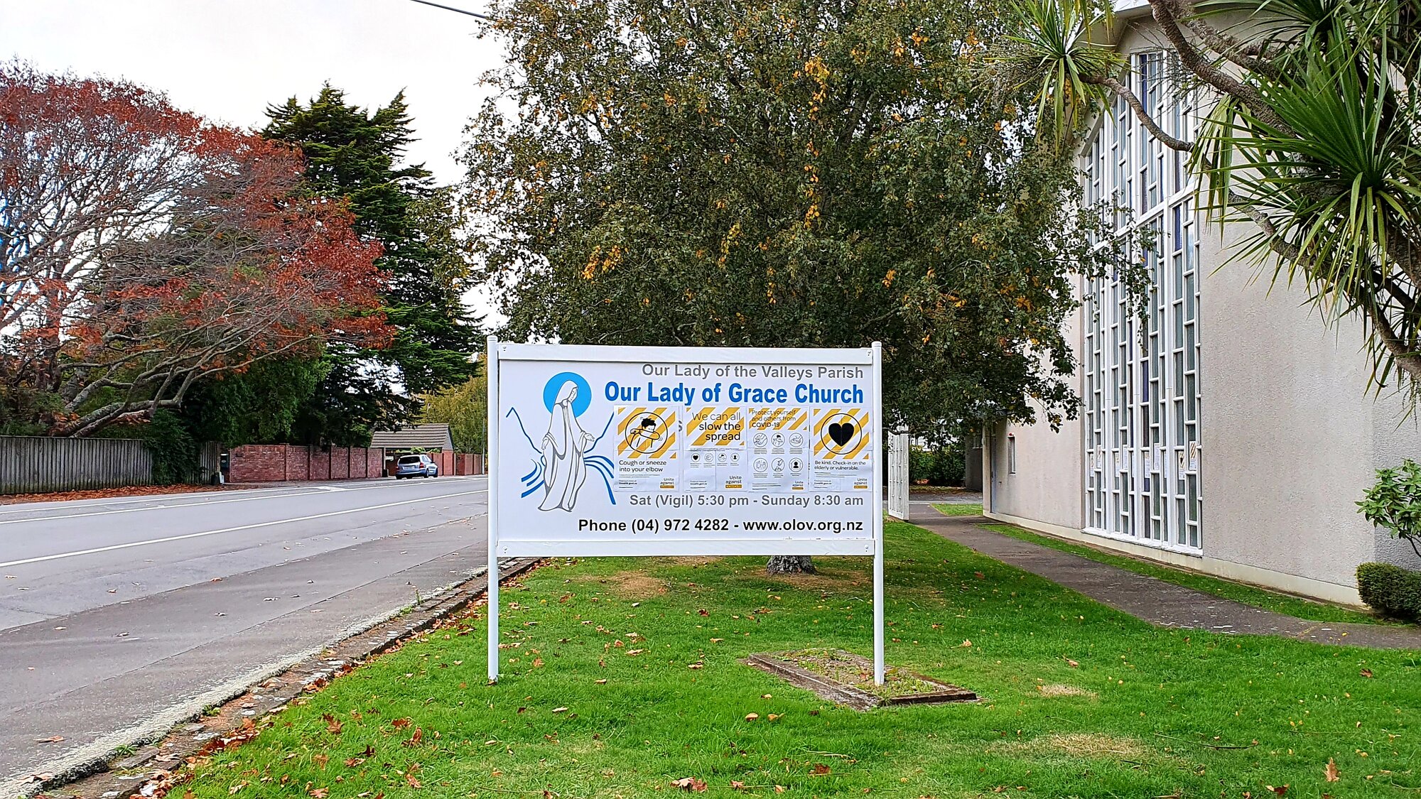 Covid-19 posters on Our Lady of Grace Church sign, Heretaunga
