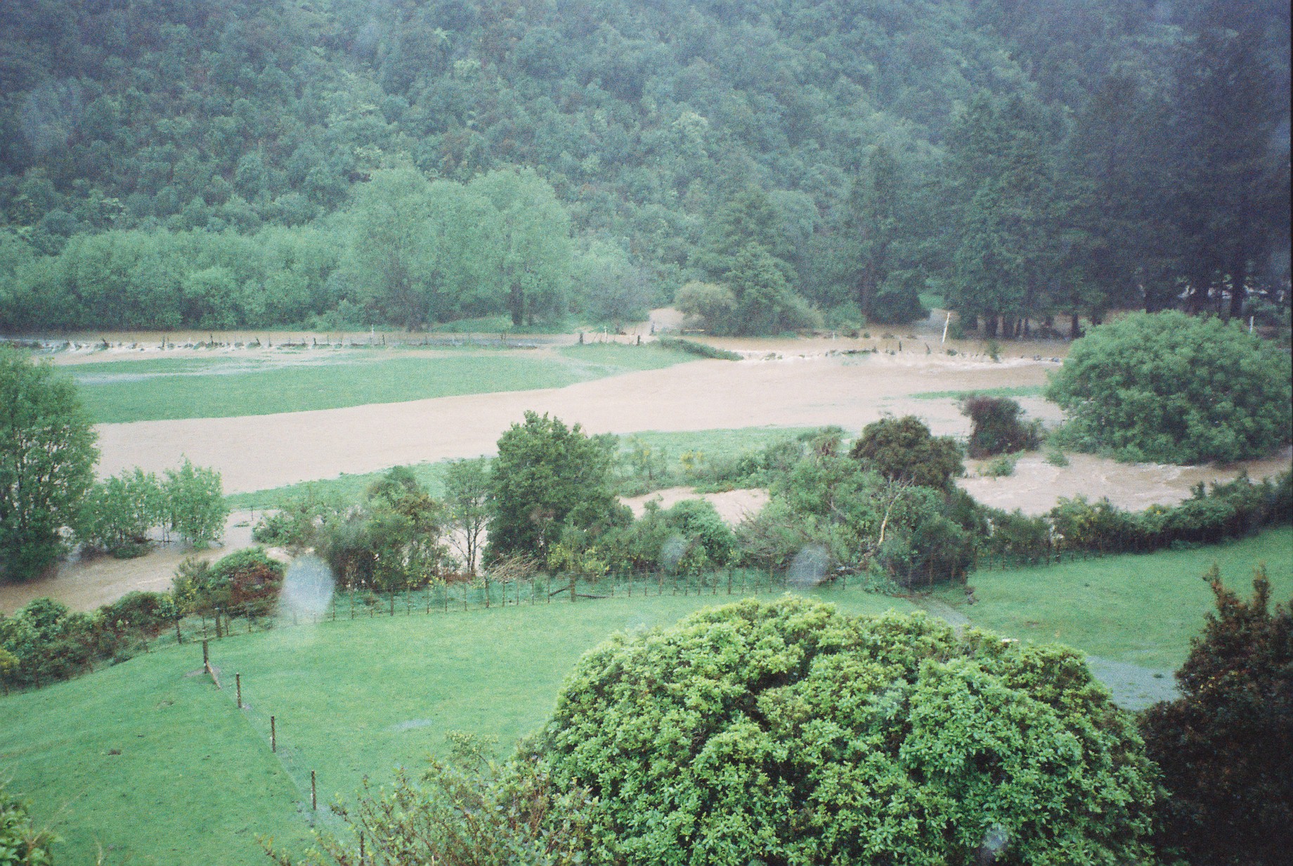 Flood, Karapoti; water crossing the road in the background.