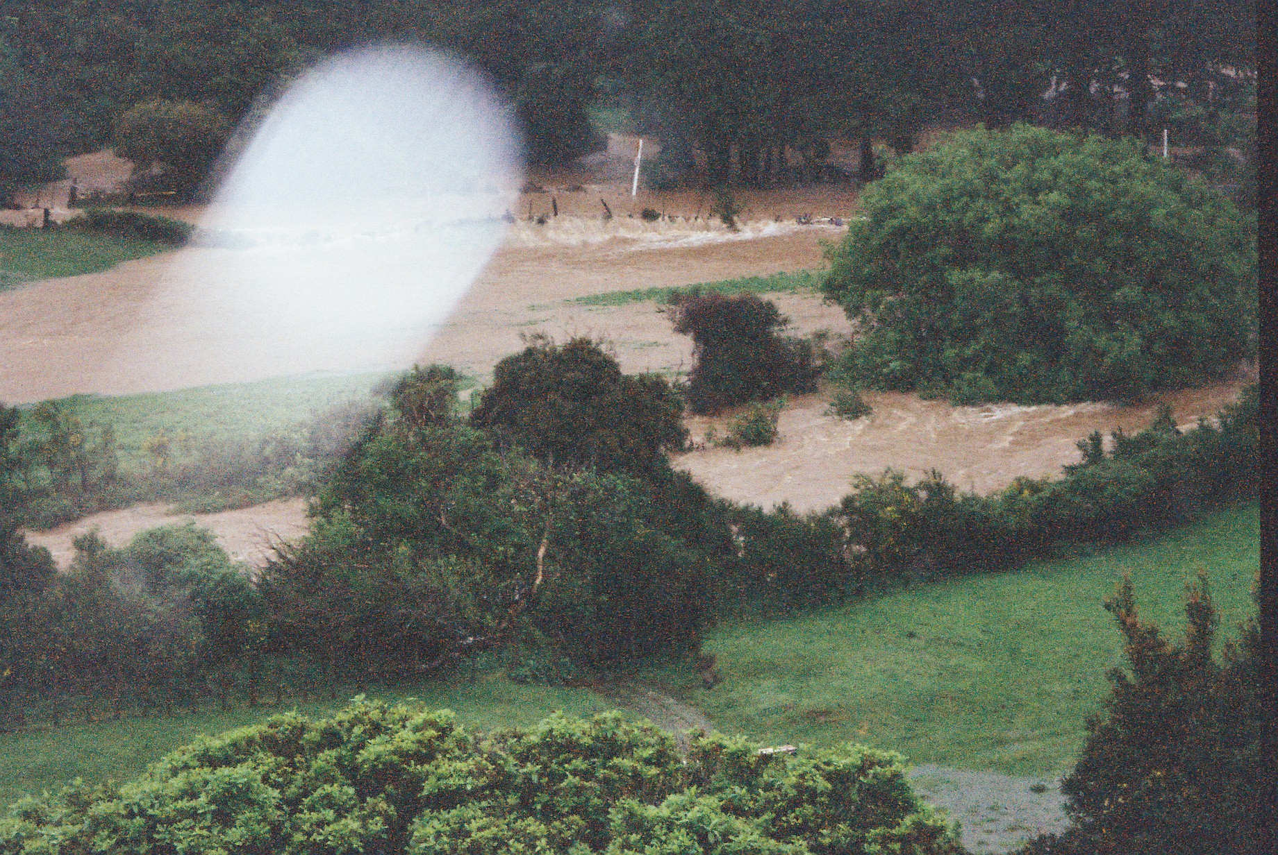Flood, Karapoti; water crossing the road, in the background; telephoto view. [P1-441-2461]