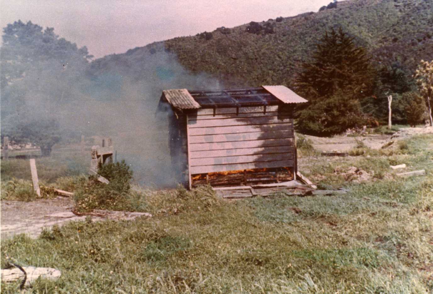Totara Park Bridge site; old hut being burnt.