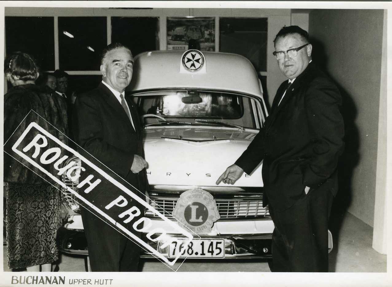 Lions Club president Bill Downs, district governor Ron Usmak at hand-over of new Chrysler ambulance.