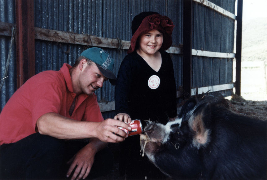 Blair Griffiths, of Katherine Mansfield Drive, with Coke-guzzling pig Suzie, and  Kadeen Williams.