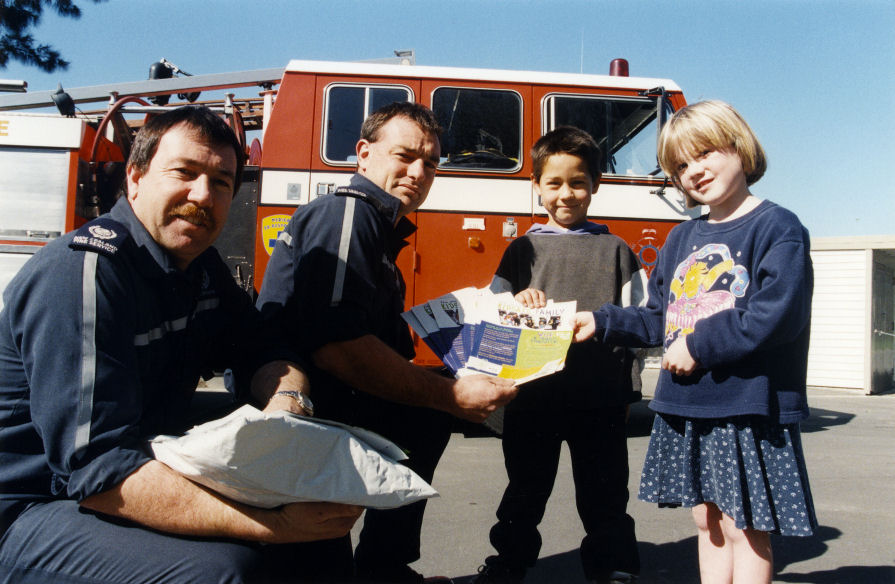 Brentwood School; firefighters Greg McLean, Tony Gibbs give Seth Nghere-Ryan and Zara King Kidsafe Week material.