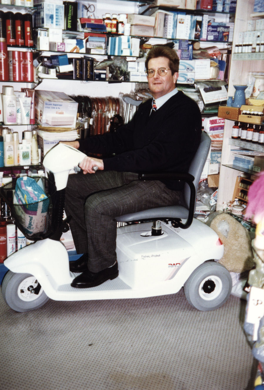 Guppy's pharmacy; owner Wayne Guppy and a Fisher and Paykel electric mobility scooter.