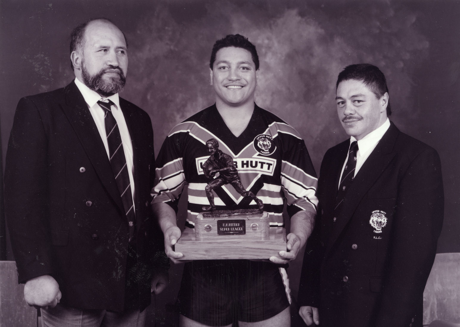 Rugby League; retiring coach Mike Edmonds, captain Mark Woods, manager Gemmell Webster and Grand Final trophy.