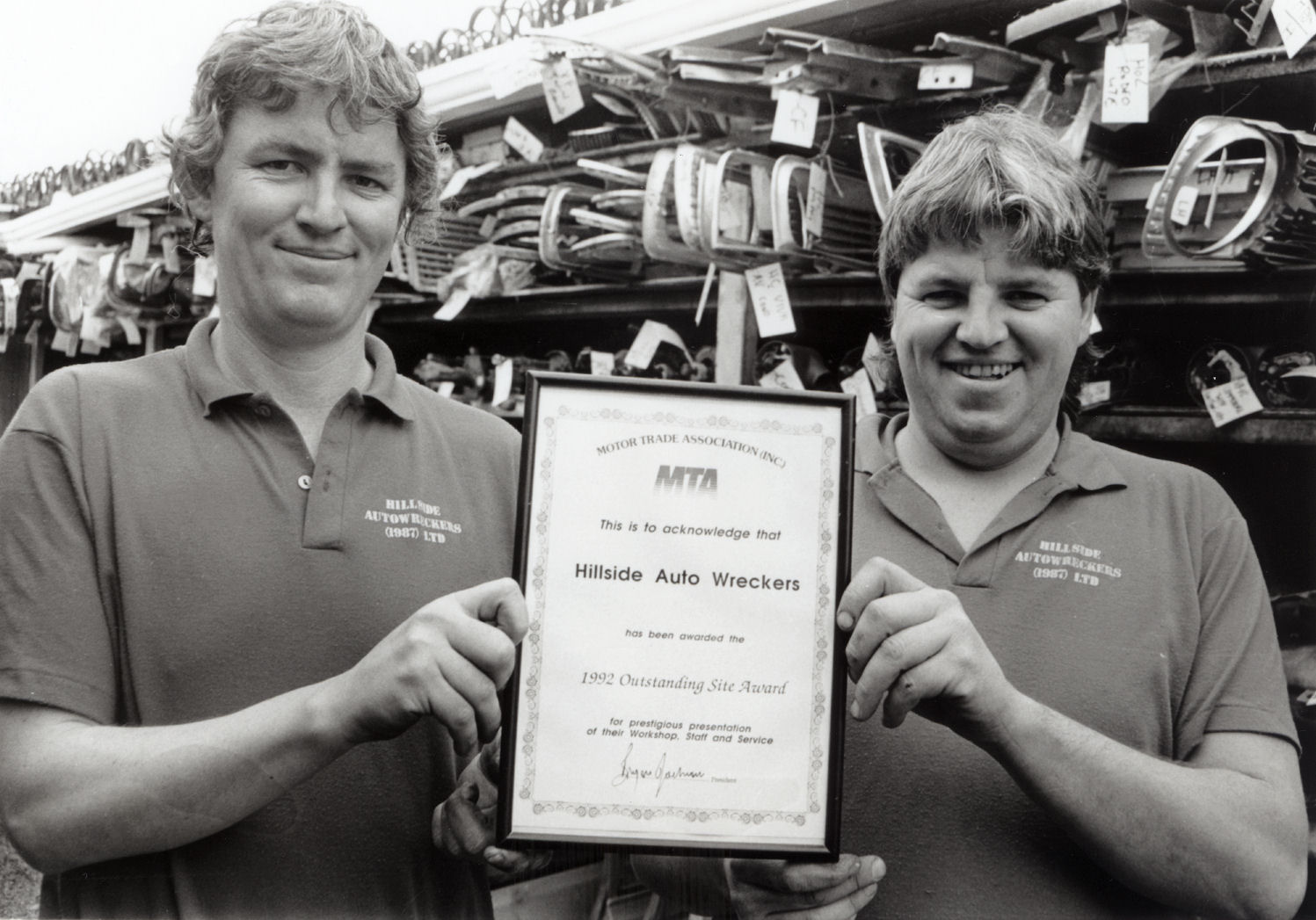 Hillside Auto Wreckers, 19 Blenheim Street; owners Ray and Malcolm Oliver with a Motor Trade Association award.
