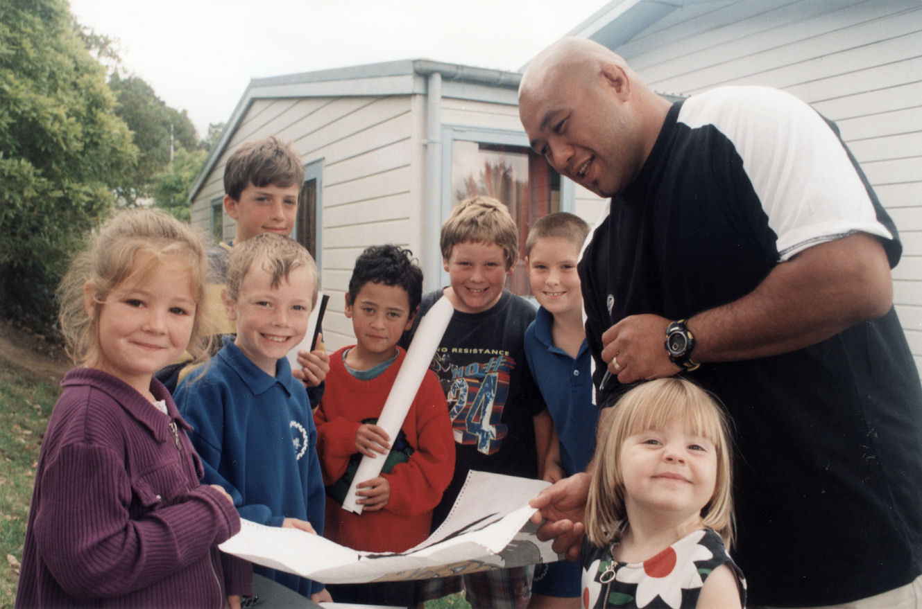 Maoribank School; Wellington Hurricanes rugby player Mike Edwards signs a poster.