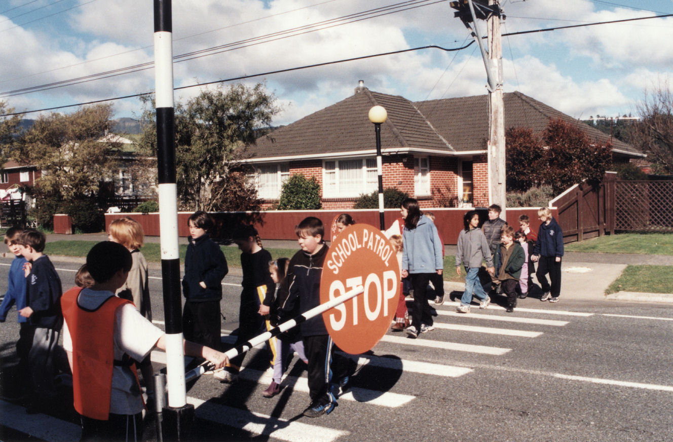 Oxford Crescent School; Year 5 and 6 pupils teaching younger ones road safety on pedestrian crossing.