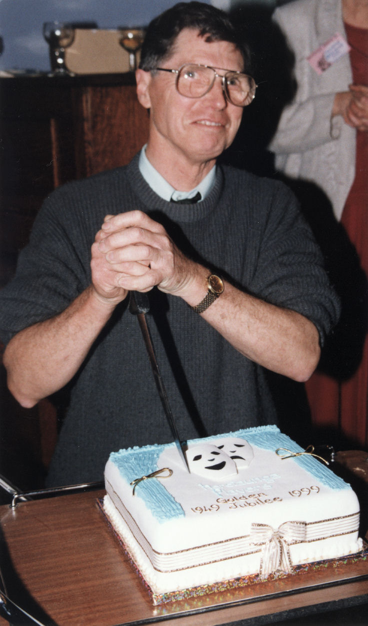 Heretaunga Players Treasurer Kevin Adams cuts the golden jubilee cake.