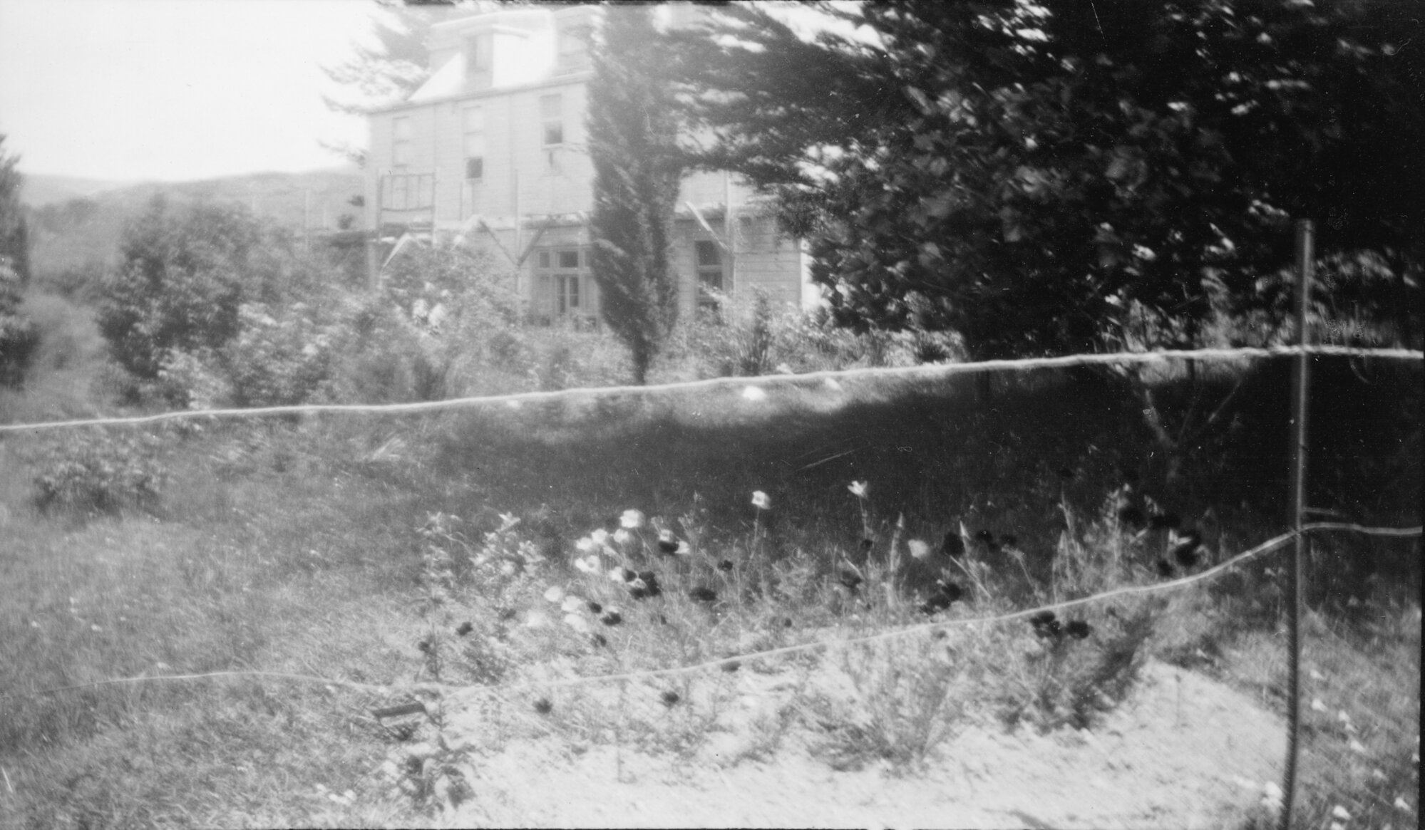 McCurdy's Castle with flower garden in foreground.