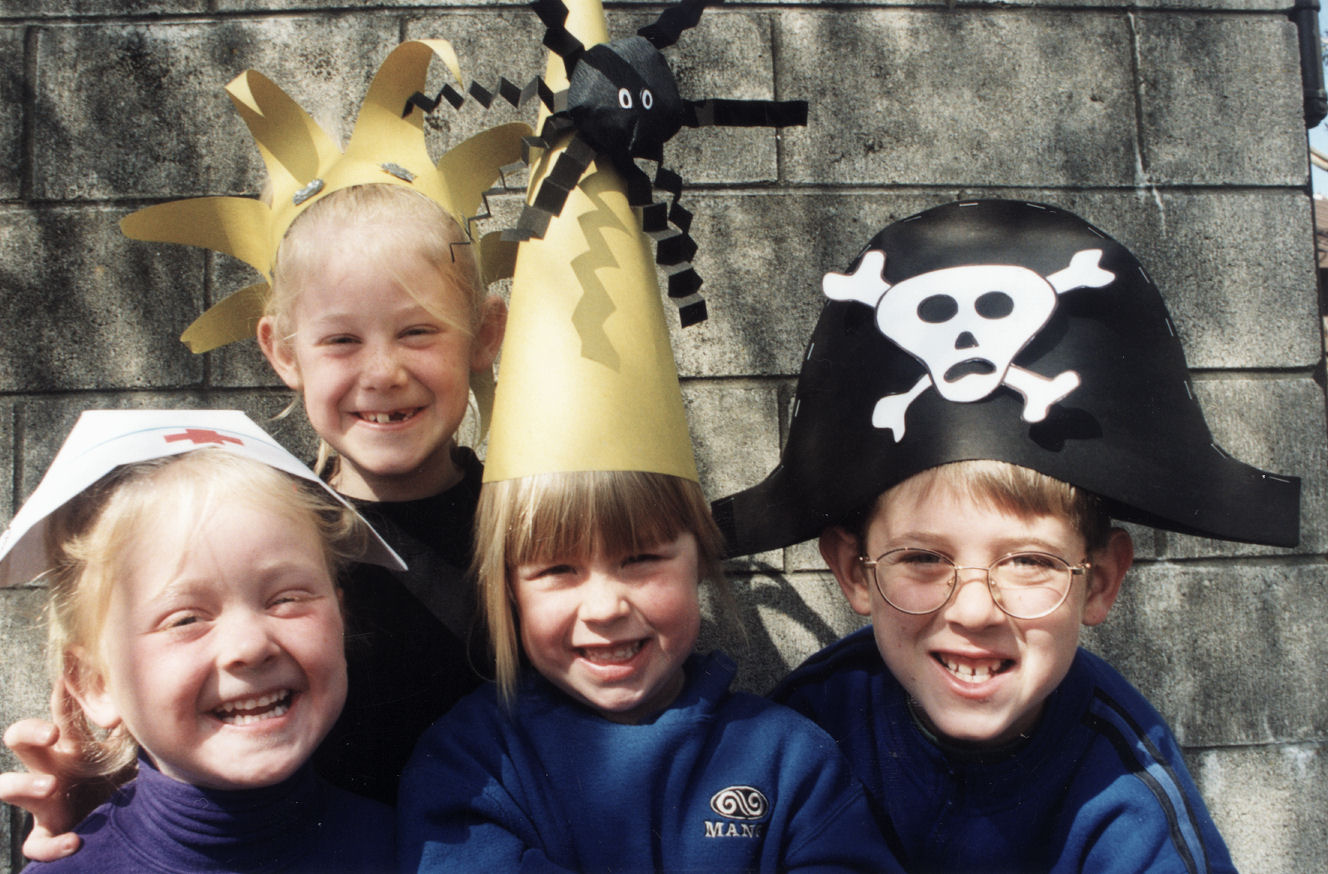 Library; school holiday programme hats; Ellen and Anna Imrie, Rachael Dobson, Todd Imrie.